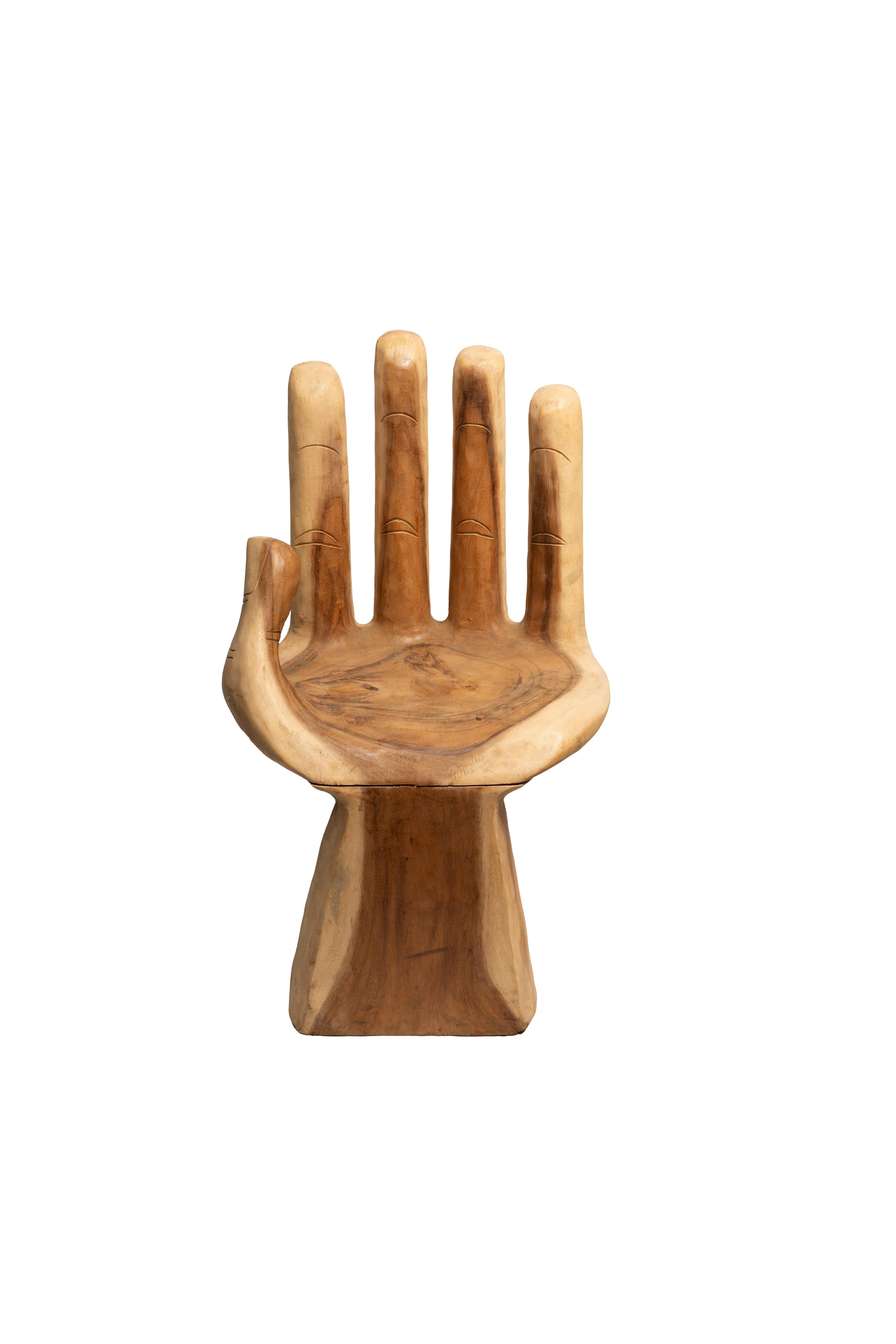 This hand-carved wooden chair is a bold blend of art and function, sculpted to resemble an open palm ready to cradle you in comfort. With its expressive finger details and warm, natural wood grain, it feels like sitting in the supportive hand of a
