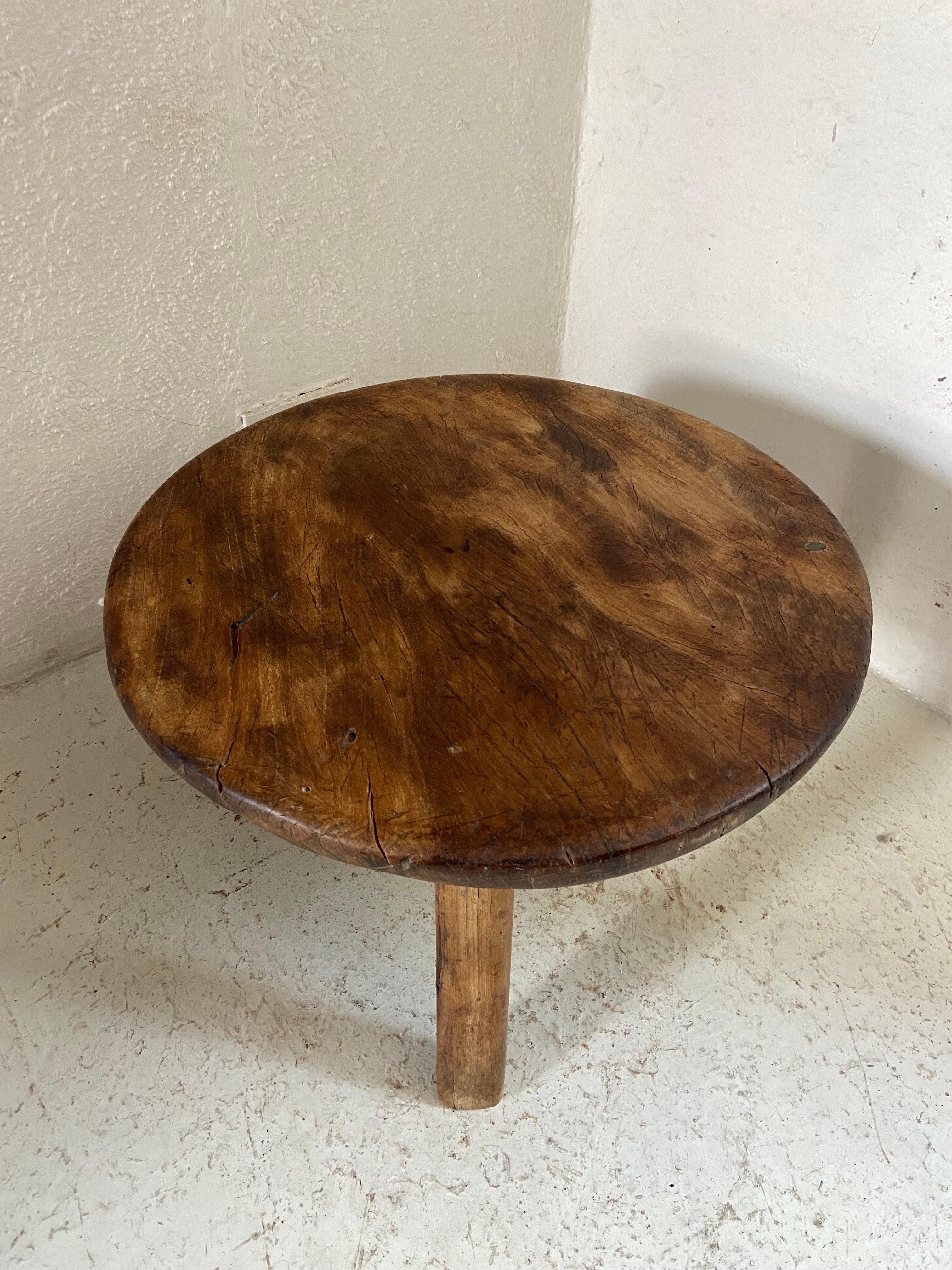 Hand carved Primitive low table from Central Yucatan, circa 1970s. This round table displays a fine example of precision, symmetry and beauty. All three legs are original which is rare, since these tables rest on mud or adobe floors which, from the
