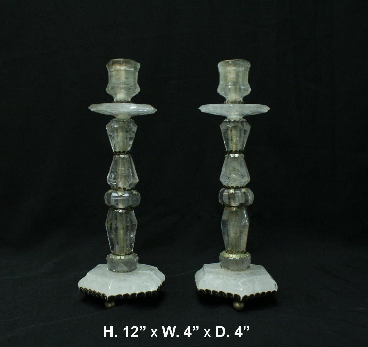 Spectacular hand carved and hand polished Rock Crystal candlesticks. 
A carved octagonal candleholder is over a conforming drip-pan, supported by a faceted Rock Crystal stem trimmed in a foliate motif, resting on a stepped base, raised on ball