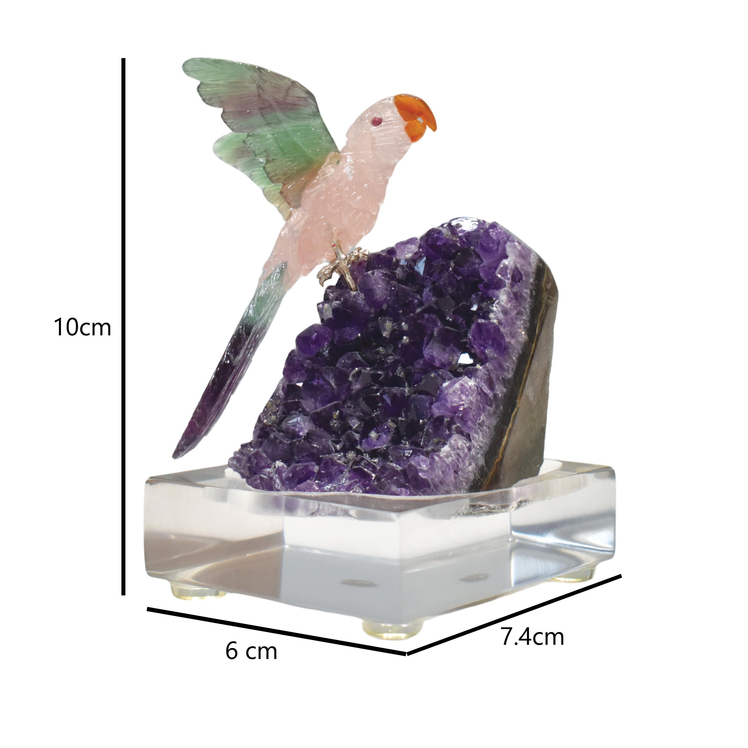 Hand-Carved Rose Quartz Bird with Fluorite Wings on Natural Amethyst Base – 10 cm x 7.4 cm

Bring nature’s beauty into your home with this stunning hand-carved bird sculpture, featuring a graceful parrot-shaped bird expertly sculpted from natural