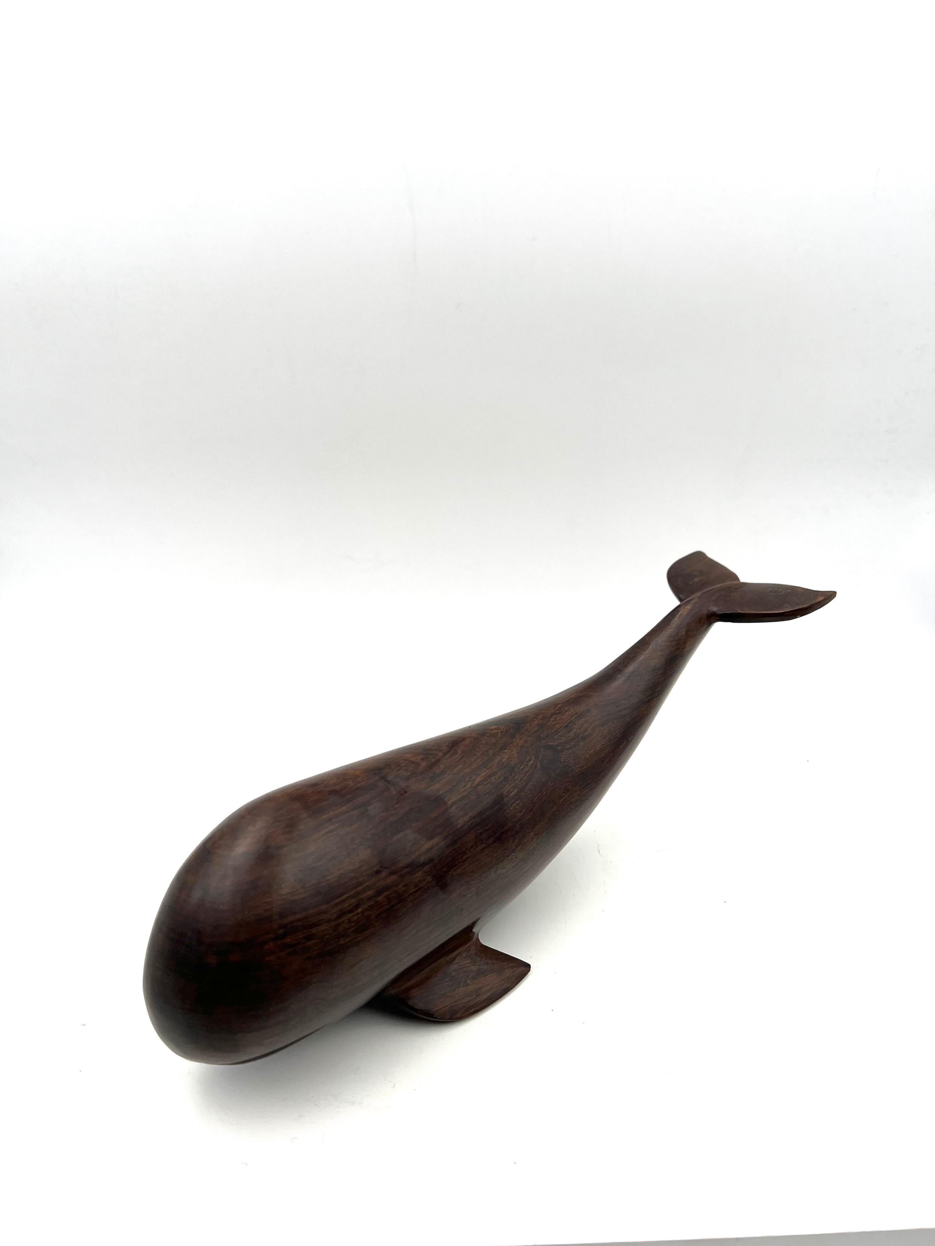 A very cool hand carved rosewood sperm whale, circa the 1980s. The piece is in great condition.