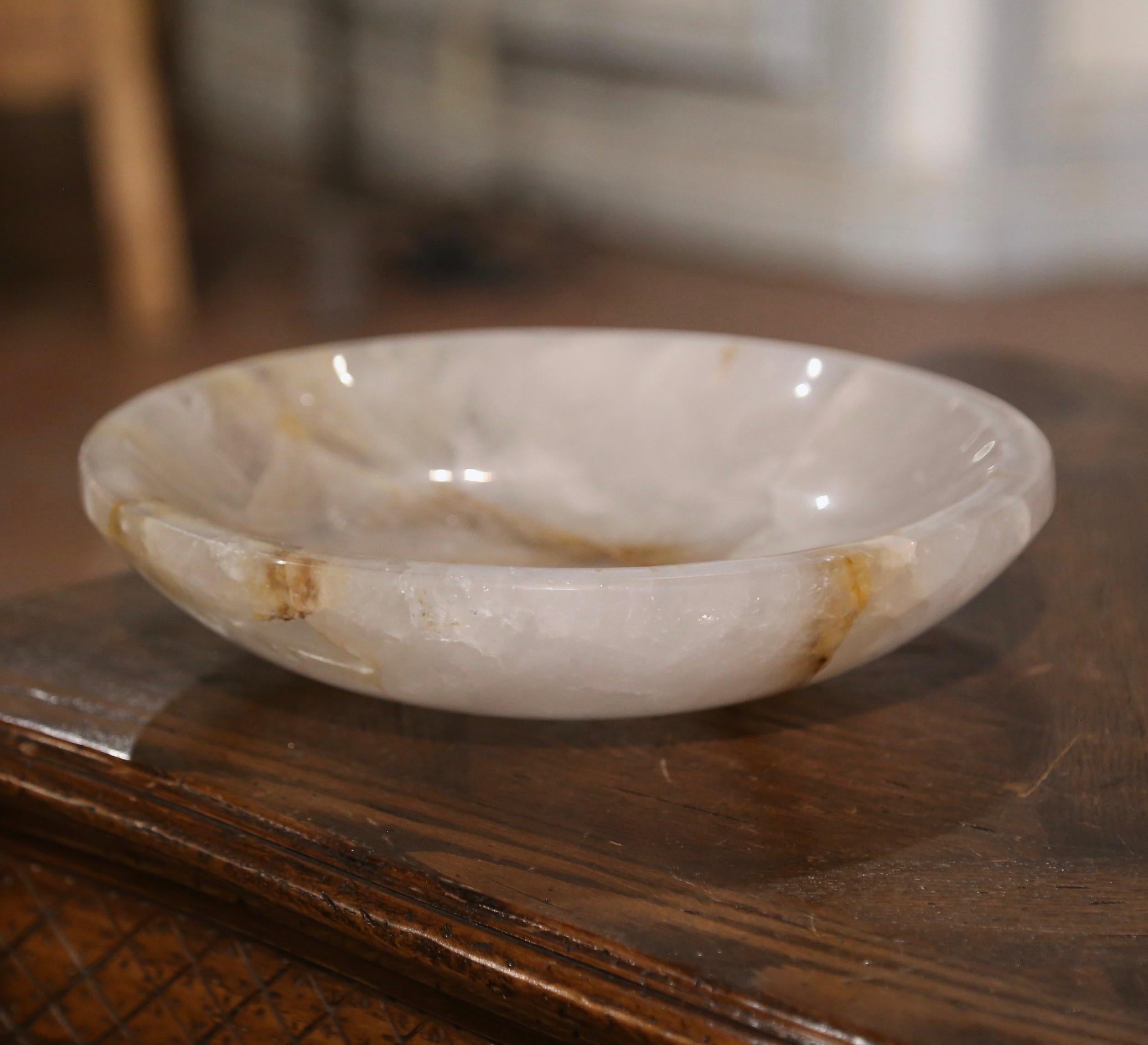 Decorate an entry table or console with this important rock crystal bowl. Crafted in Brazil, the hand carved dish is round in shape. The circular dish in excellent condition commensurate with age and use and adorns a rich patinated clear finish with