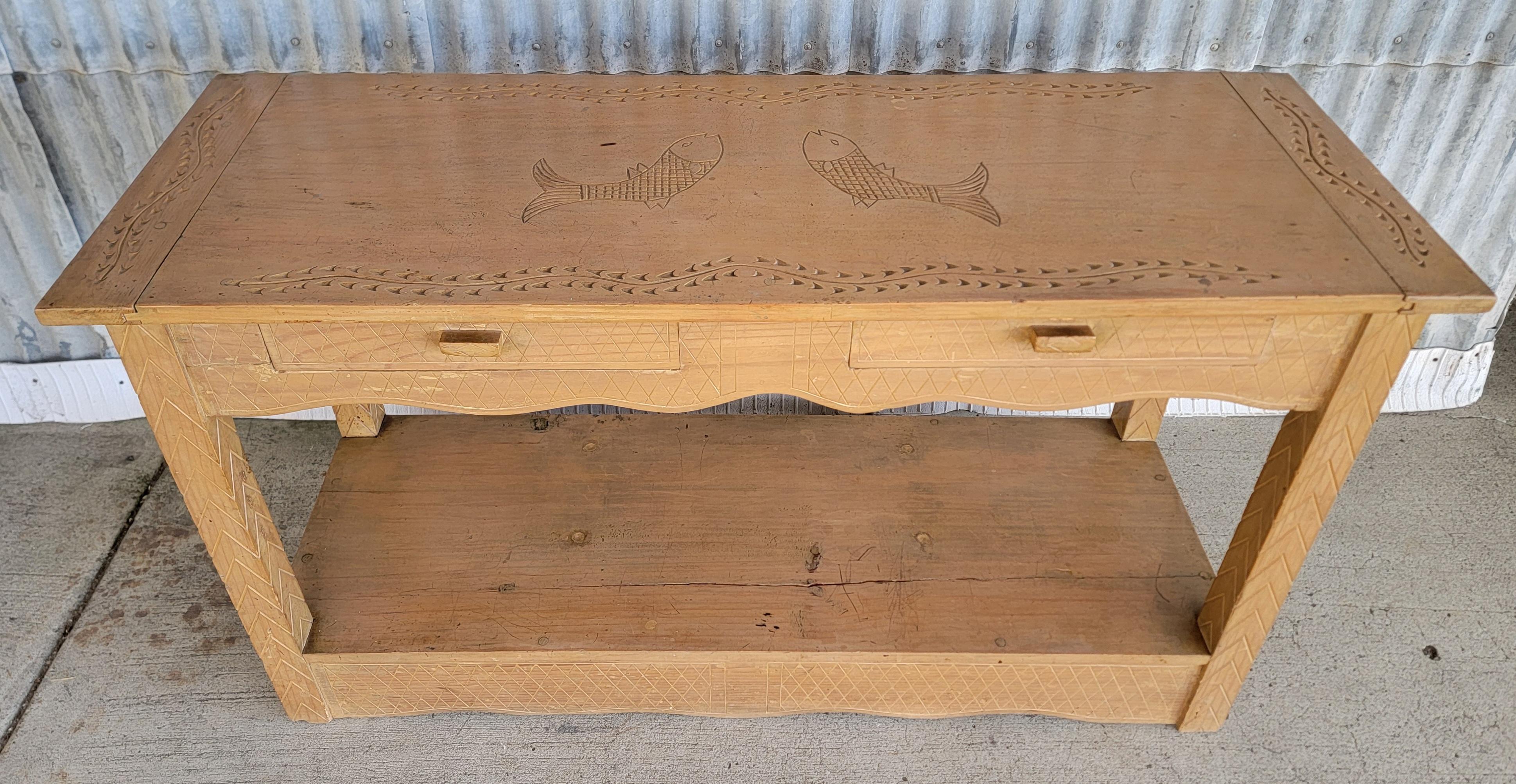 Unique hand-carved and hand-made Rancho, Monterey style console or sofa table. Made in Mexico, circa. 1940's. Features two drawers and lower shelf area. A nautical, fish carved top surface, unusual for the Rancho style. 

54 inches wide.
19 inches