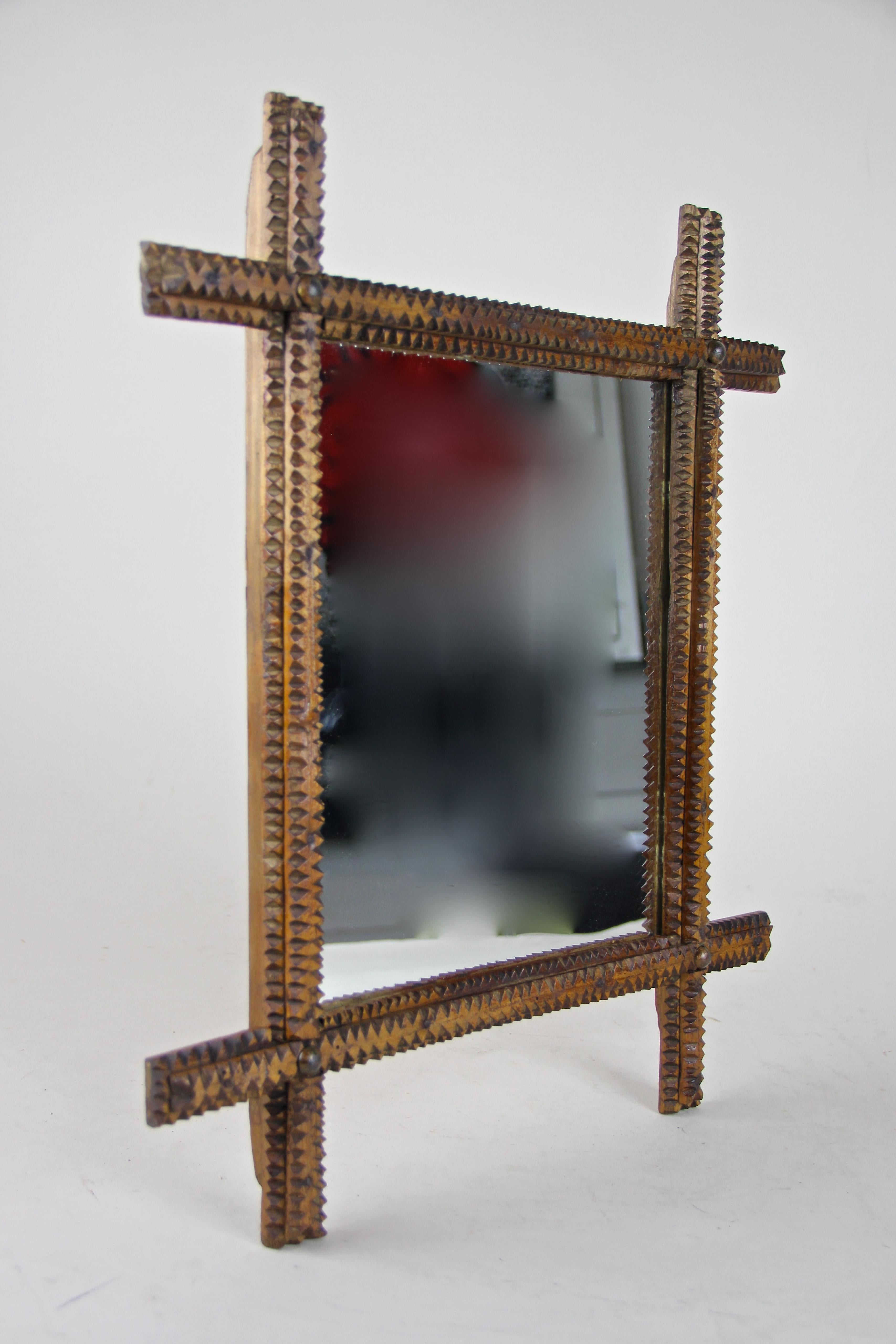 Lovely hand carved rustic wall mirror in beautiful Tramp Art design from Austria circa 1870. This late 19th century wooden mirror comes with a classical shape showing overhanging corners and a rough carved surface. Typical, or let’s say better -