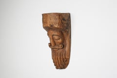 Hand-Carved Rustic Wooden Mask with Soft Expression