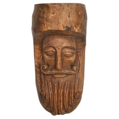Hand-Carved Rustic Wooden Mask with Soft Expression