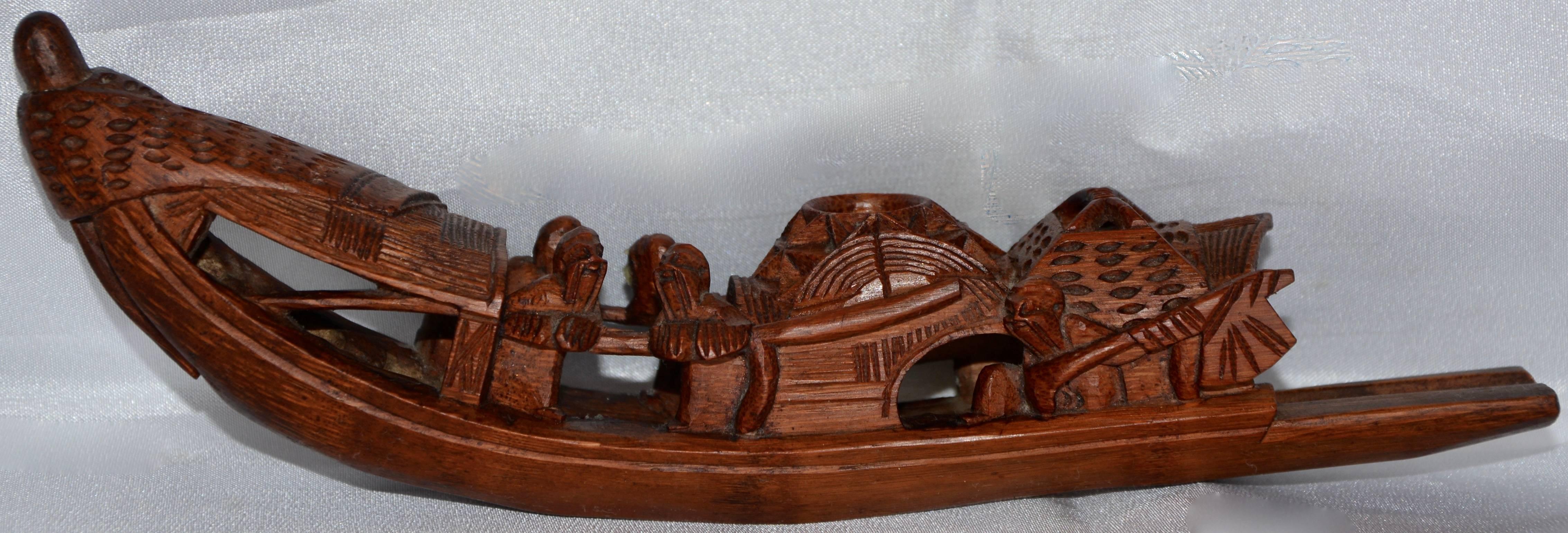 Hand carved details are lovely on this unusual incense burner. The men are rowing the boat and appear to have a smile on their faces. The back has a slip to place your incense.
