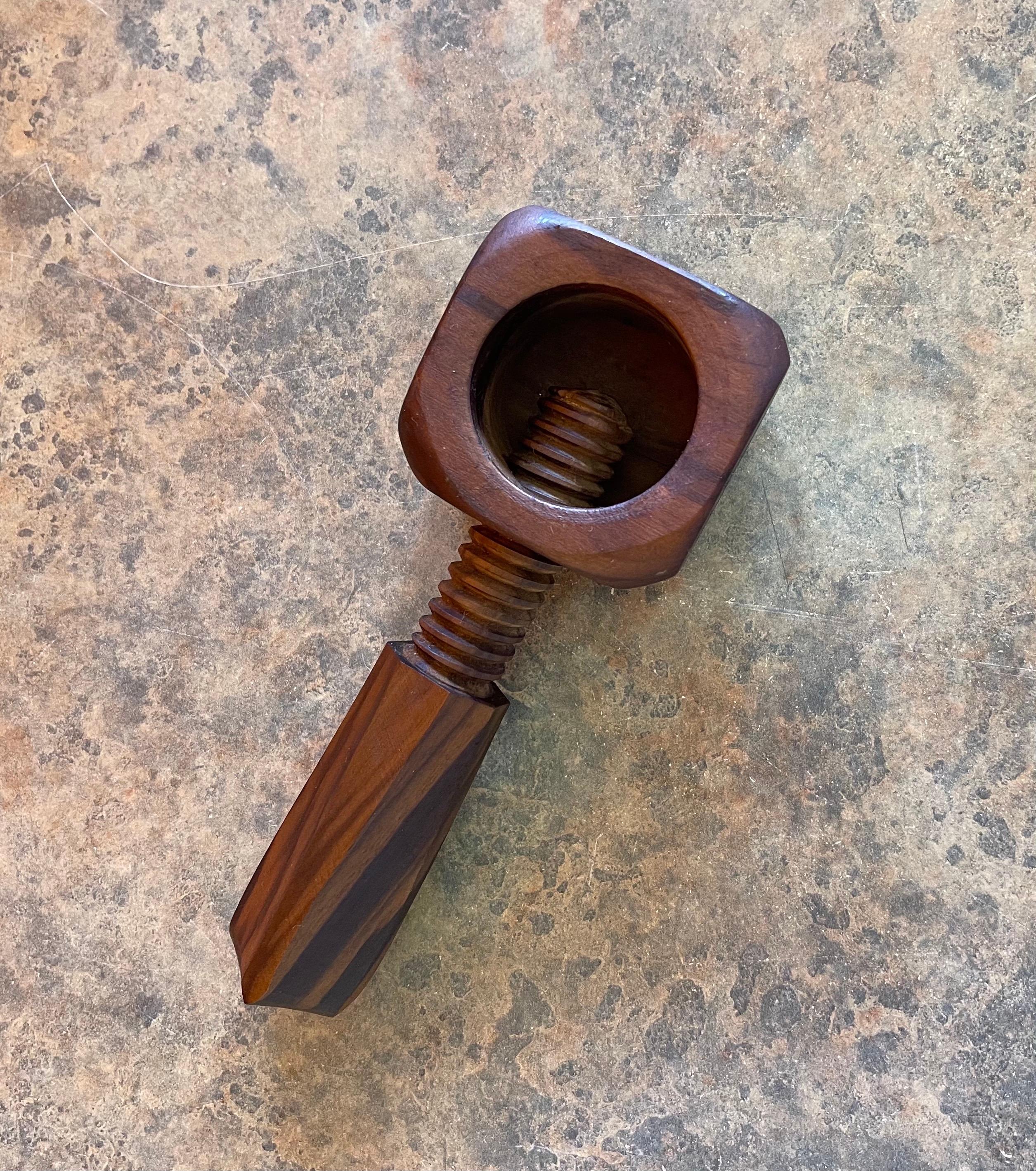 A very nice hand carved screw type nut cracker in walnut, circa 1970s. The nut cracker is in very good vintage condition and measures 6.6