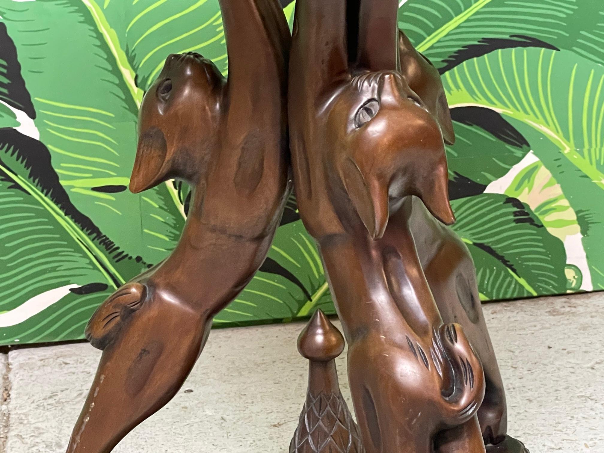 Hand carved side table features a fun motif of three cats forming a pedestal. Deep brown finish and a whimsical touch to any decor. Good vintage condition with minor imperfections consistent with age.