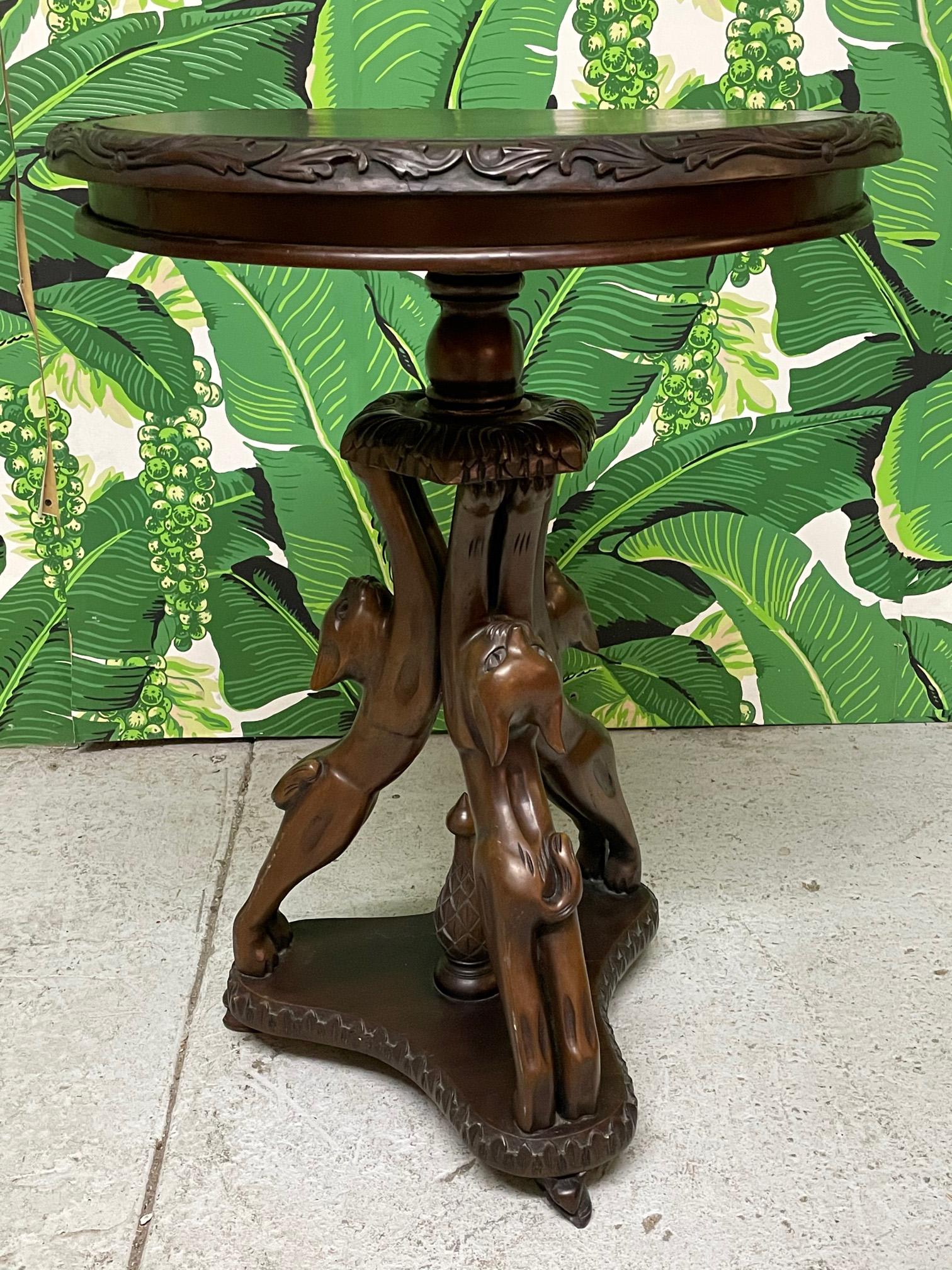 Hand carved side table features a fun motif of three cats forming a pedestal. Deep brown finish and a whimsical touch to any decor. Good vintage condition with minor imperfections consistent with age. May exhibit scuffs, marks, or wear, see photos