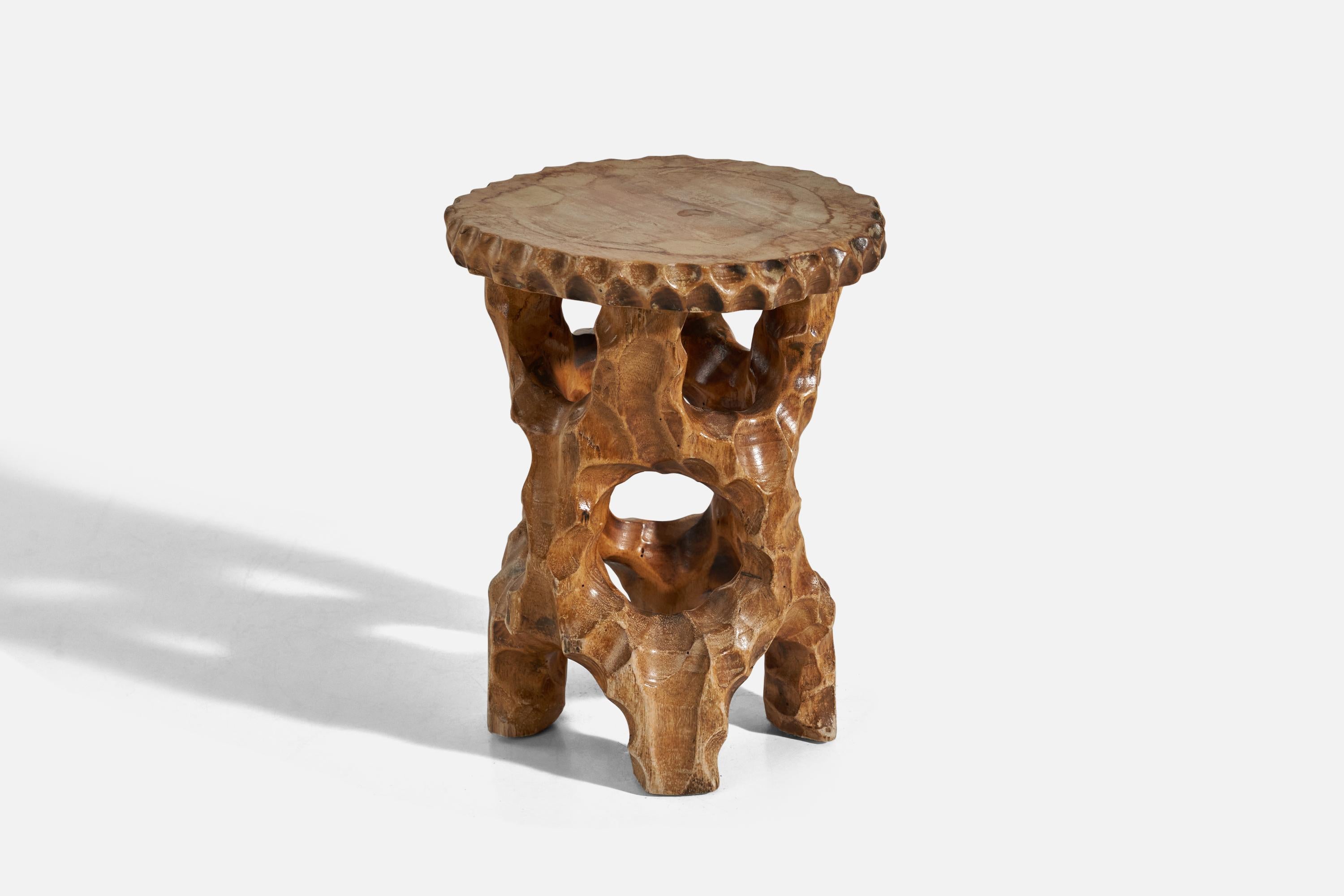 A stained and lacquered, carved wood stool designed and produced in Sweden, circa 1950s. 