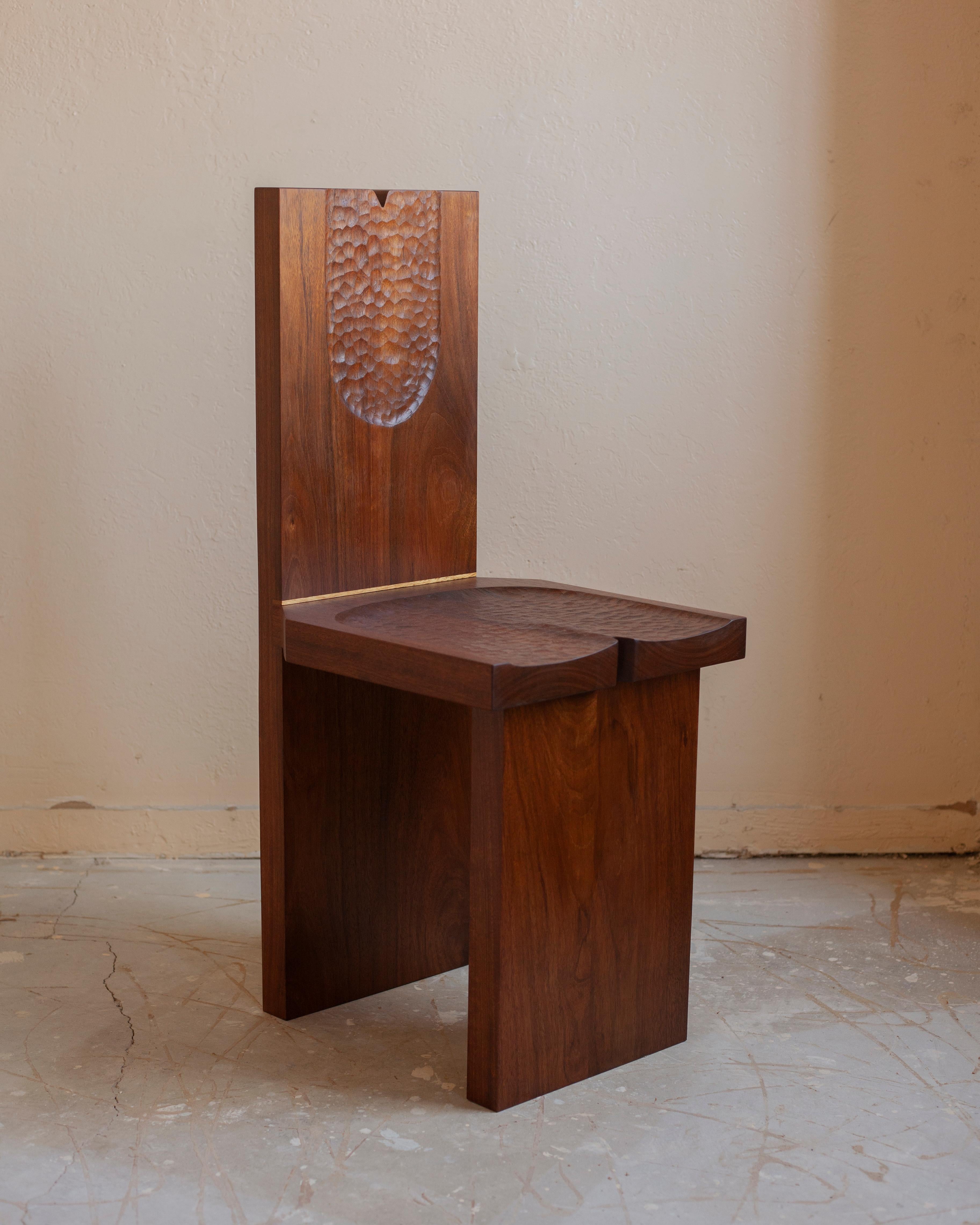 Hand-Carved chair in solid Shedua wood made by Roly Gomez of CFP. 

Edition of 10. 

Features both a hand-carved seat and backrest. 

Also features an Iroko wood inlay.