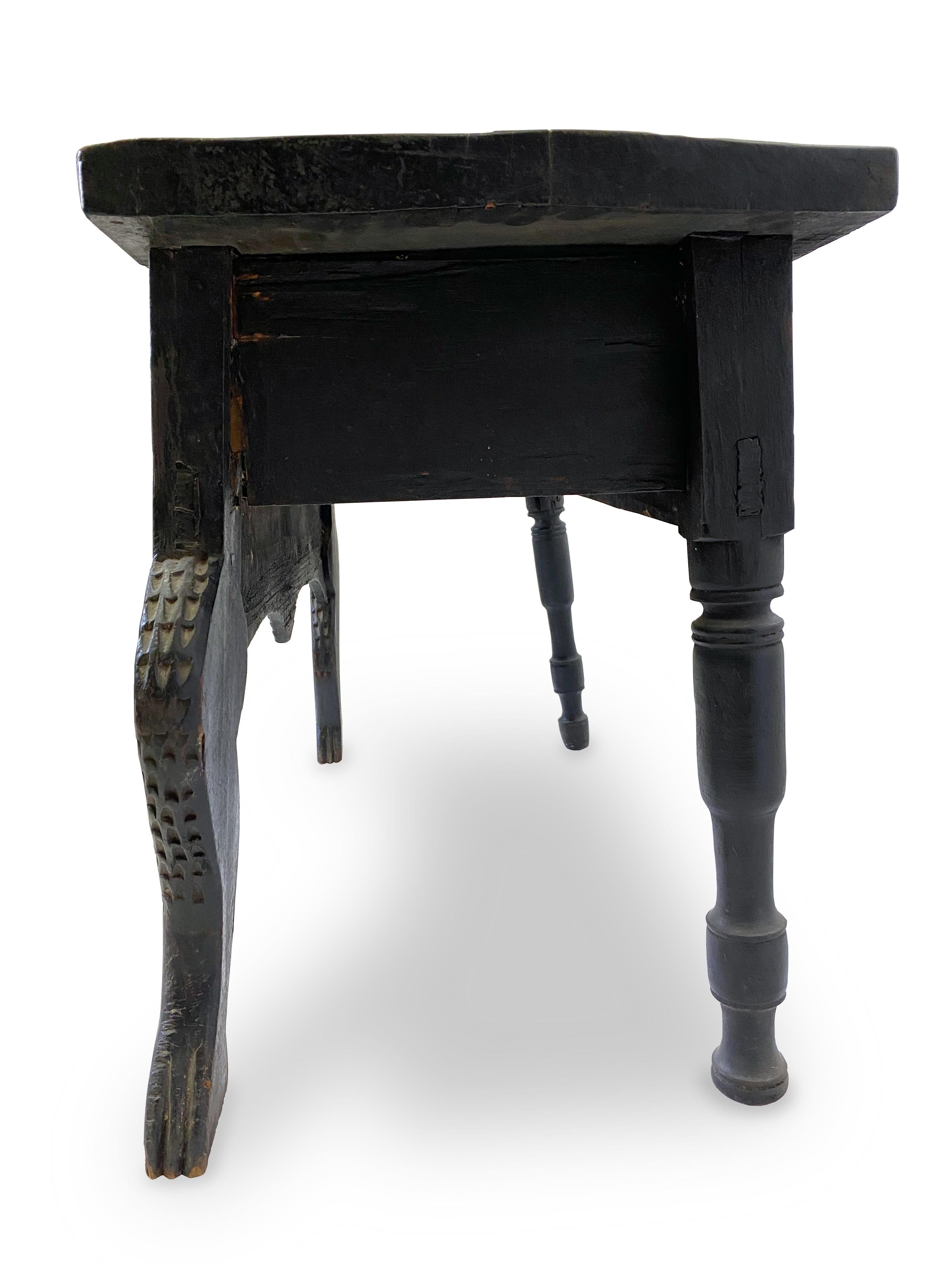 Exquisitely hand-carved antique side table from the highlands of Guatemala. This is a Nahuala (animal Spirit table) table. It has beautiful stylized animal front legs, three drawers, and detailed carvings throughout. With its rustic carved animal