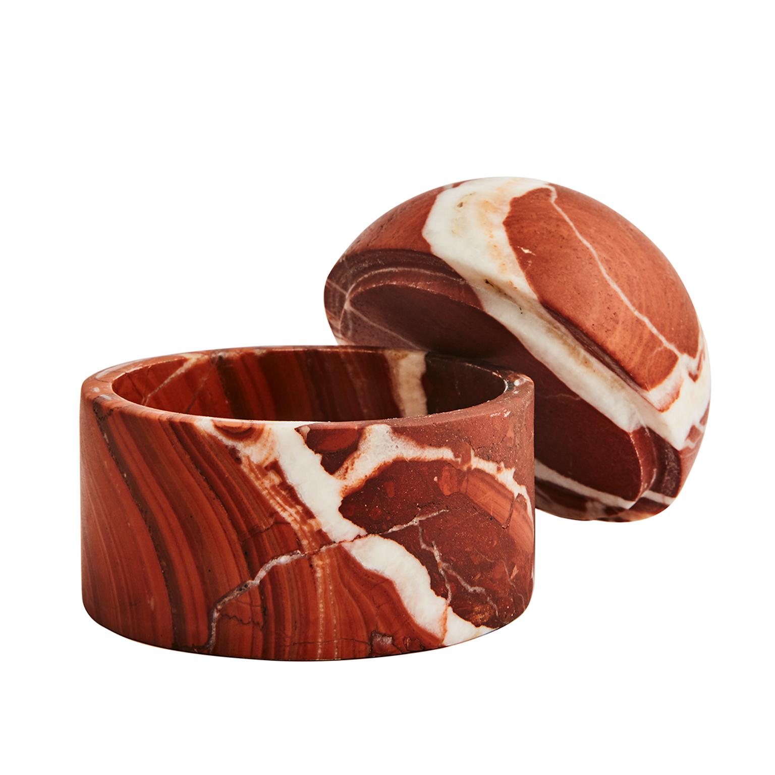 These playful beehive-inspired domes are beautiful decorative pieces that also conceal your most prized possessions. This family of vessels are hand carved and offered in two sizes. The vibrancy of the Rosso Marble plays well with the texture and