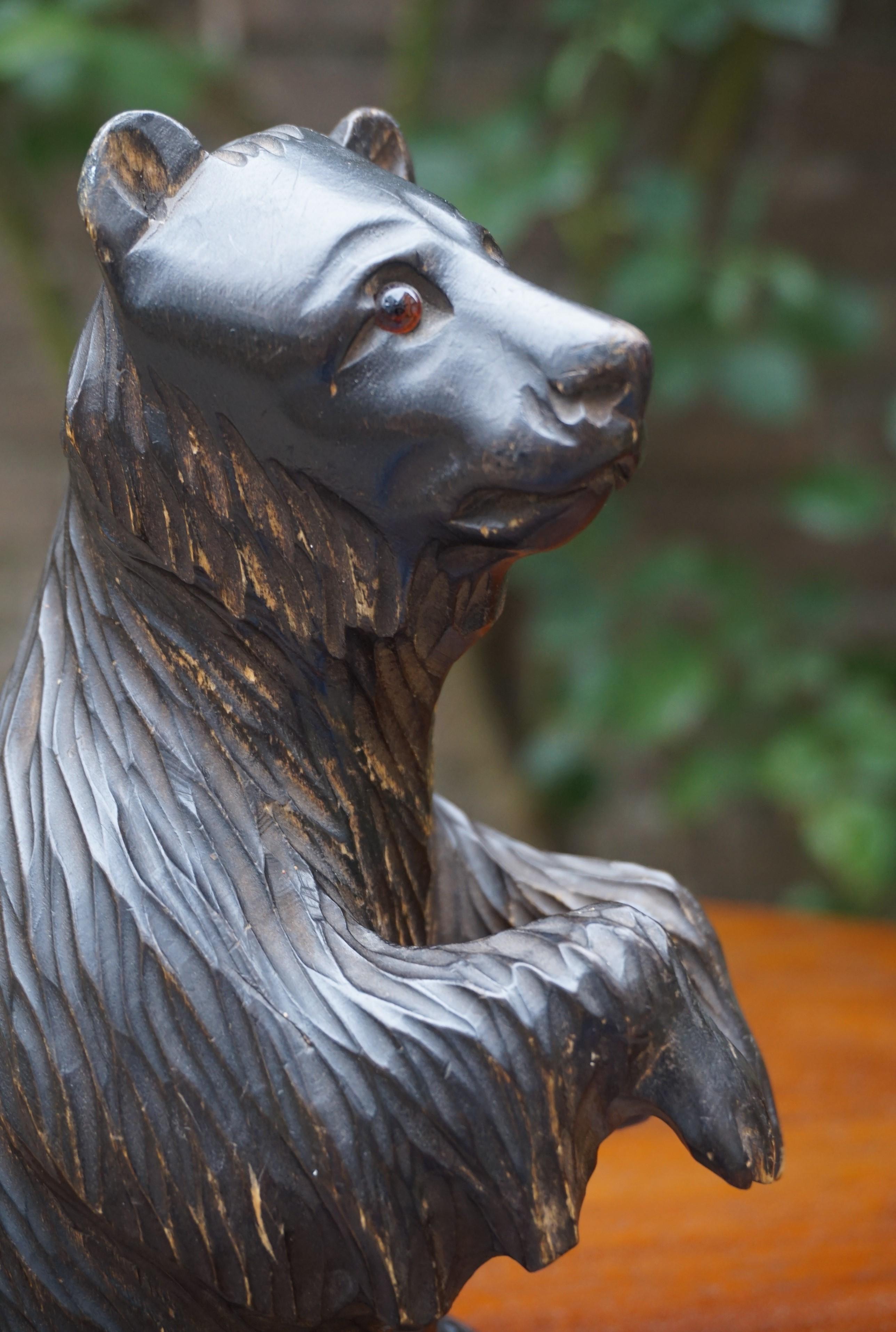 One of a kind, sitting bear sculpture with colored glass eyes and lots of character.

This early to mid-20th century sitting bear sculpture from Russia (see image 13 & 14) has the most beautiful facial expression and it takes a true artisan to be