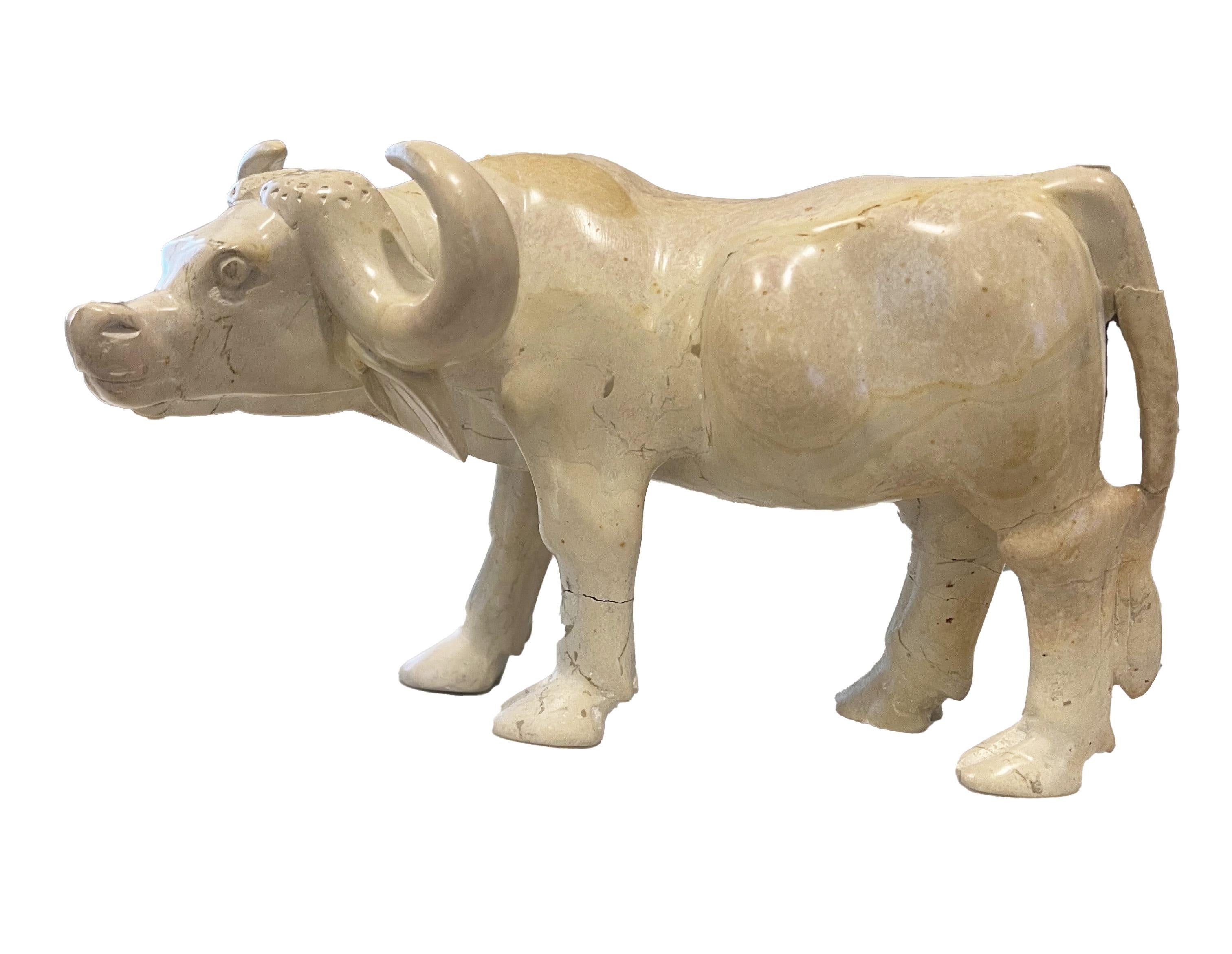 A found soapstone cattle statue, hailing from the heart of Kenya. Each curve and contour of this exquisite piece has been meticulously carved, showcasing the artisan's skill and attention to detail. Particularly remarkable are the realistic details