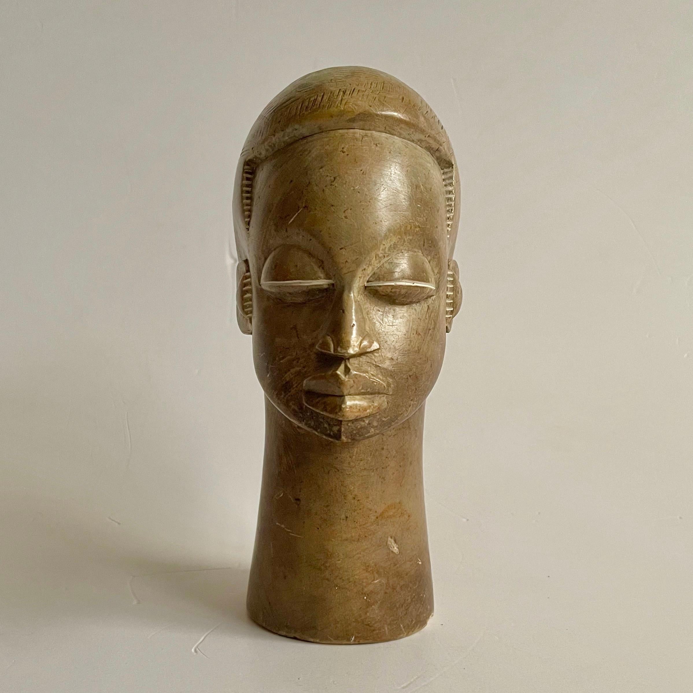 A beautiful soapstone hand-carved head of an African tribe-woman circa 1940. 