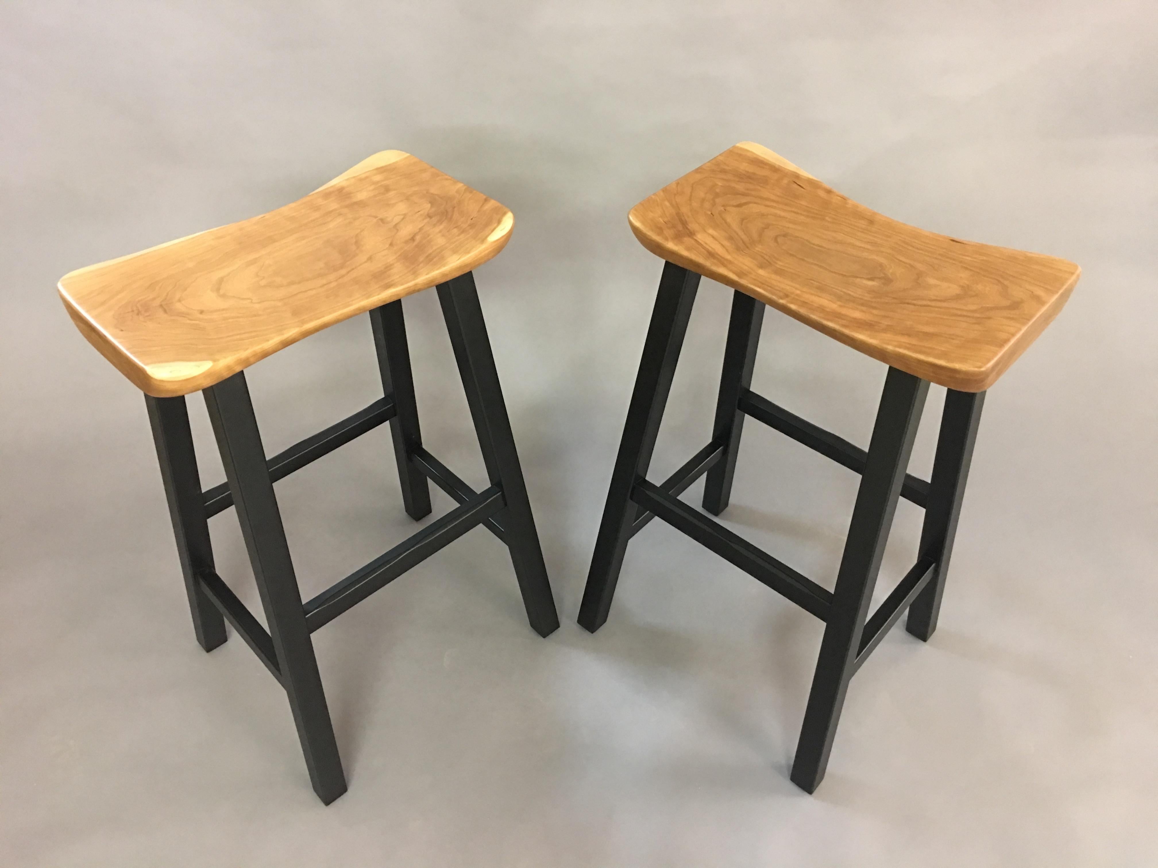 Hand-sculpted solid cherry seats with blackened hardwood bases. Bases are assembled with mortise and tenon joinery. Can be modified for bar or counter height. Custom woods are also available.