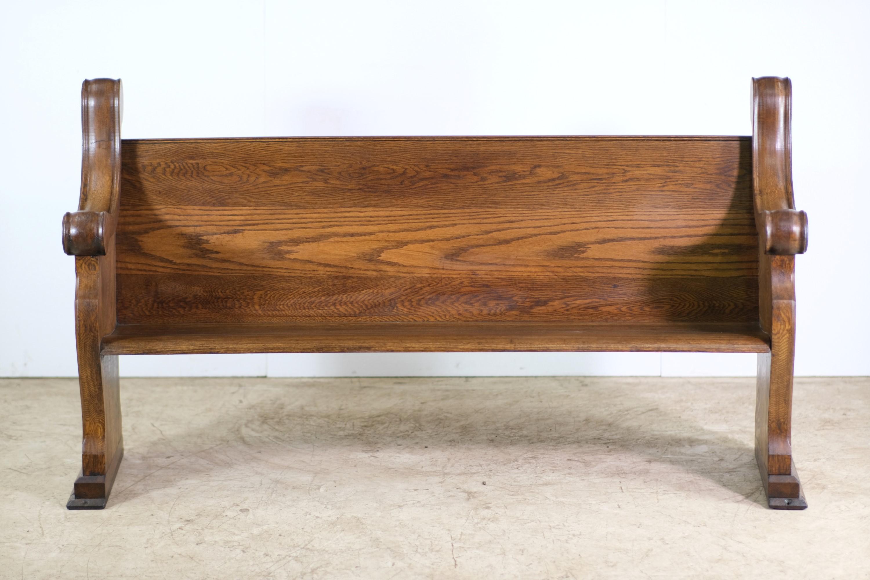 Restored early 20th century dark stained oak church pew. This features hand carved floral details and a quatrefoil on each end. This can be seen at our 2420 Broadway location on the upper west side in Manhattan.
