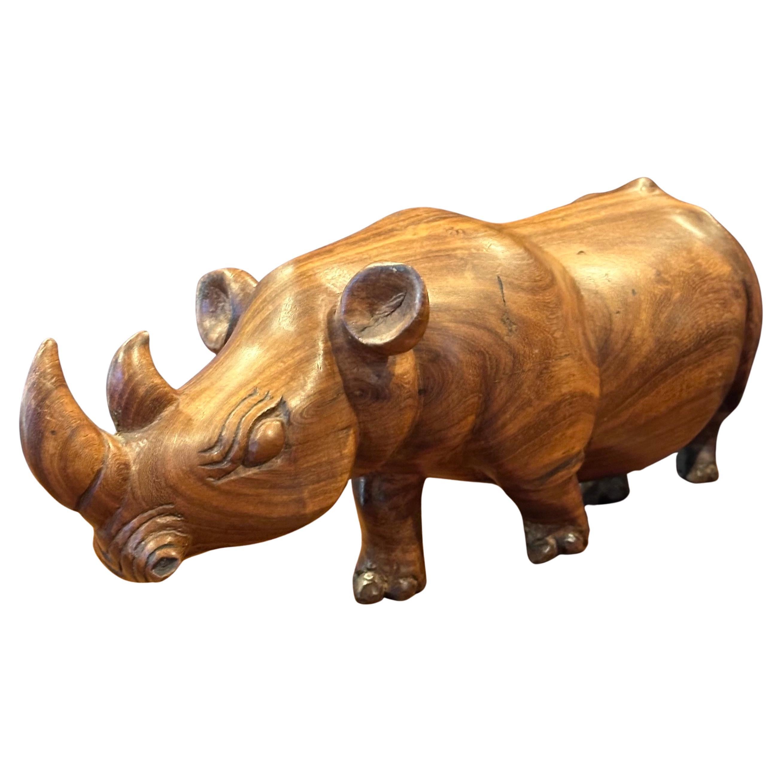 A very cool hand-carved solid walnut white rhino sculpture, circa 1980s. The piece is in great condition and measures 4.25