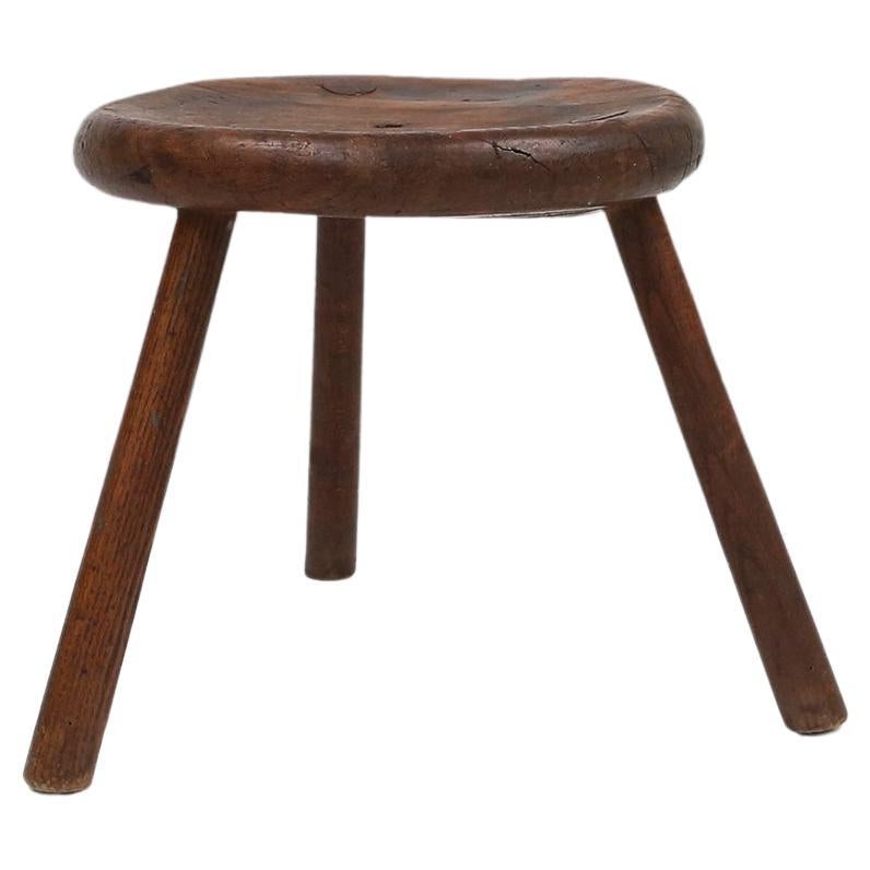 France / 1900 / stool / wood / rustic / mid-century / french provincial 

Mid-Century wooden French tripod stool, made around 1900. This brutalist stool has beautiful patina from years of use. The thick seat is  slightly hollowed out for more