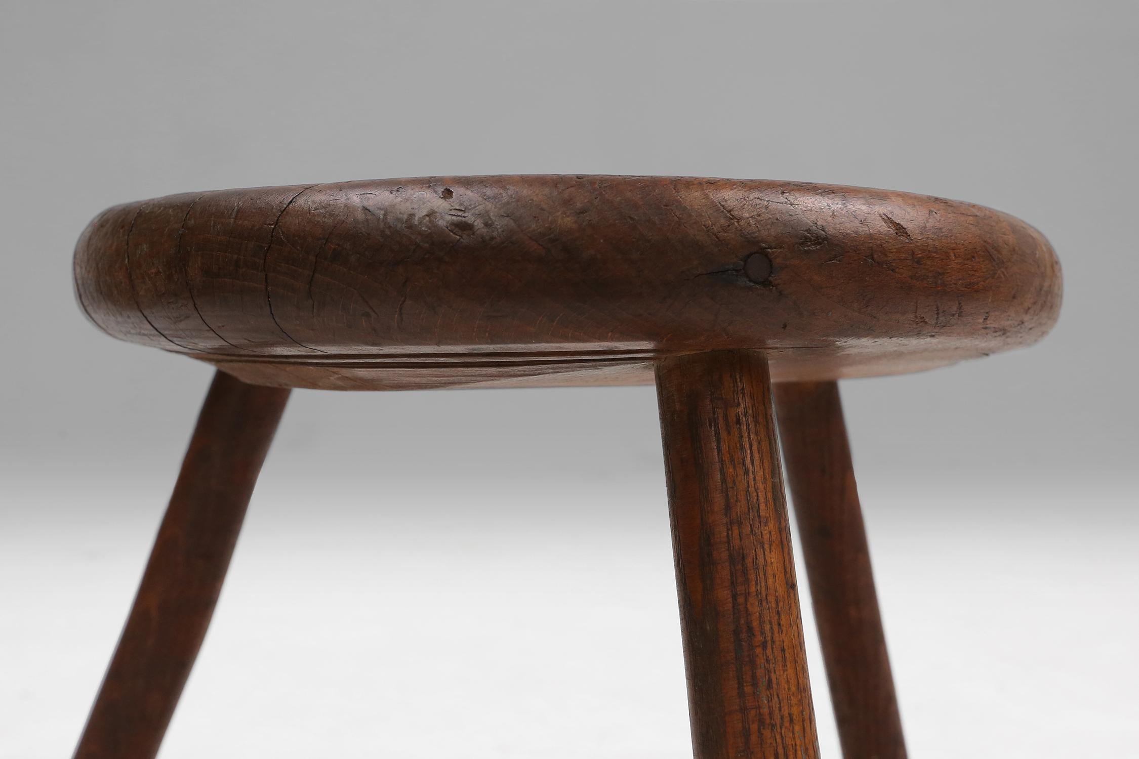 Early 20th Century Hand-carved solid wood tripod stool with beautiful patina, France ca. 1900 For Sale
