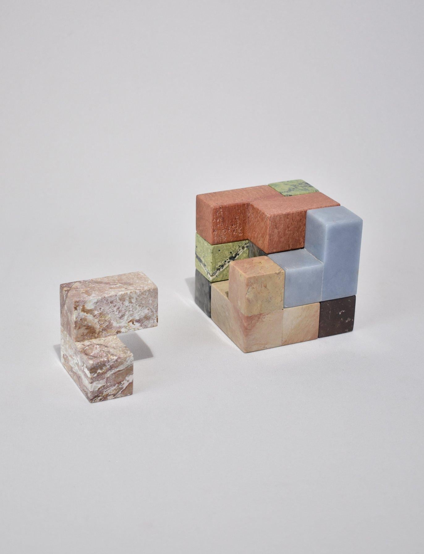 Hand-carved soma cube puzzle sculpture in a mix of 7 brightly colored semi-precious stones that form a perfect square (with 32 ways to solve). A beautiful coffee table piece or sculptural object when not in use and the perfect gift for architects,