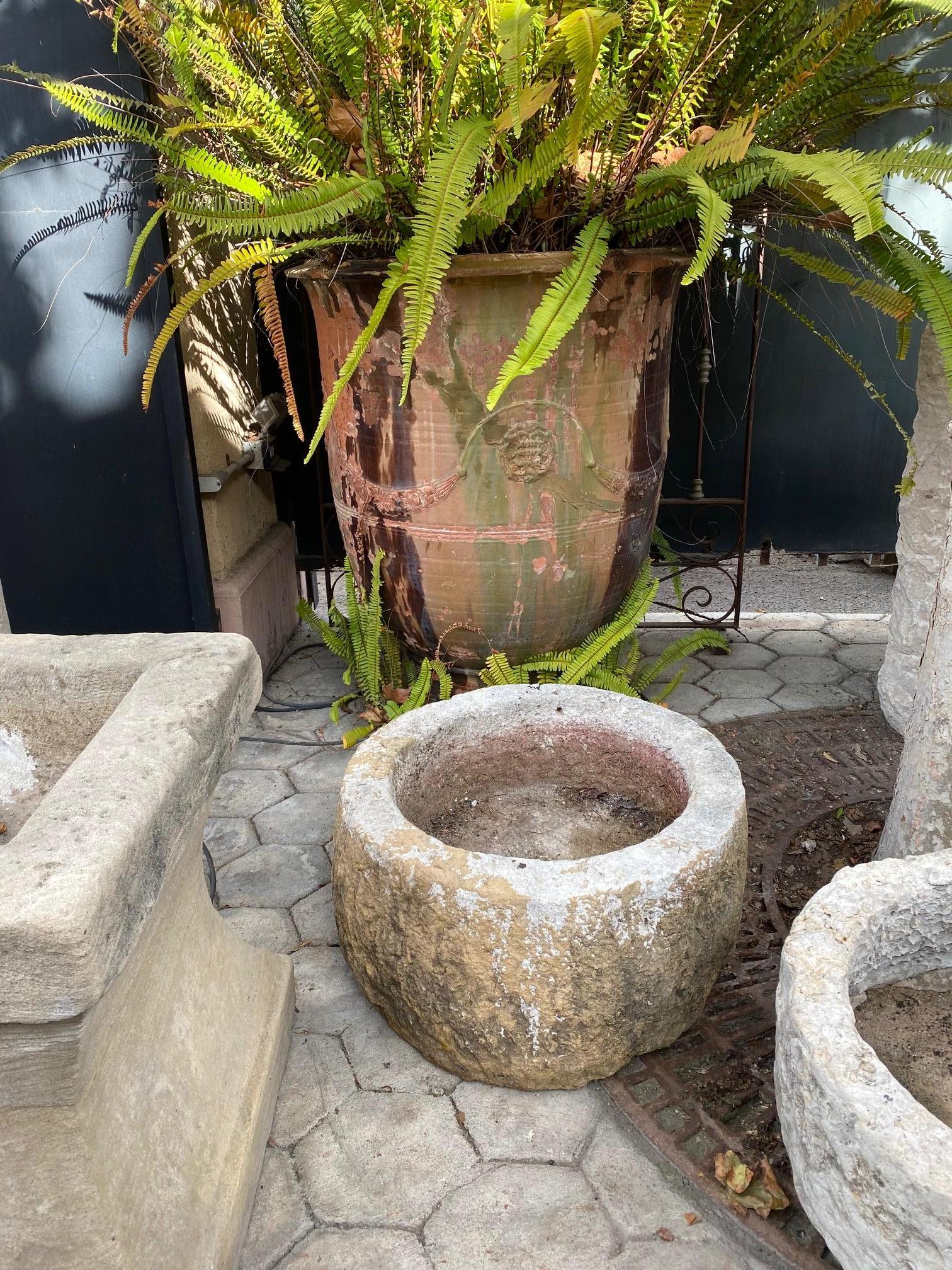 A beautiful 18th / 19th century hand carved stone container basin having a nicely textured surface and patina. It could be standing alone as a decorative object or used as a planter indoor outdoor. This antique stone vessel mortar planter has a lot