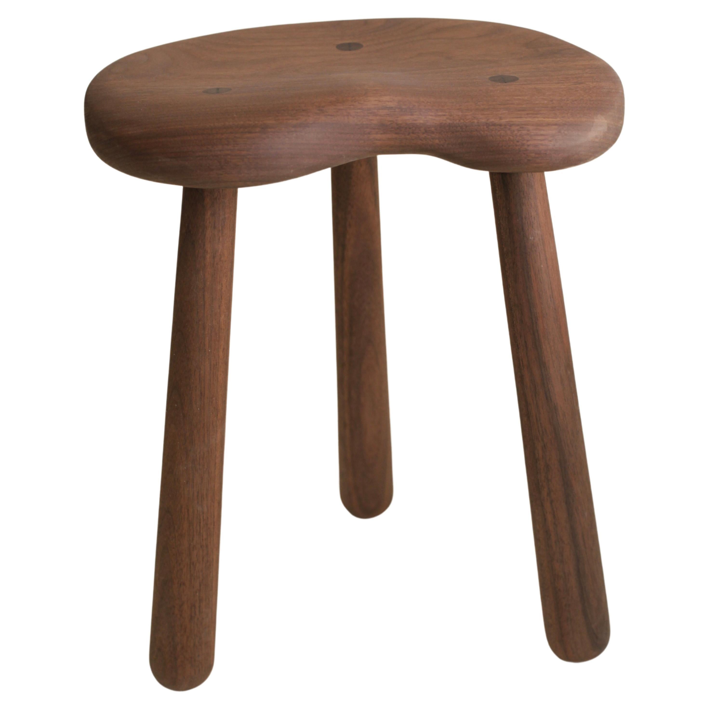 This hand carved stool in walnut with a tractor seat was originally designed for a client who asked for a comfortable stool in their steam shower. It was first made in teak. We liked it so much that we started making it in walnut, as seen above, as