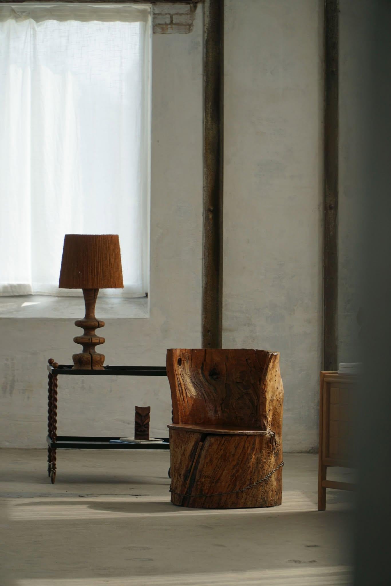 A charming rustic stump chair, hand-carved from solid pine and accented with an iron ring. Crafted by an unknown Swedish artisan in the early 1900s, this piece embodies the spirit of wabi-sabi and adds character to modern interior design.

Its