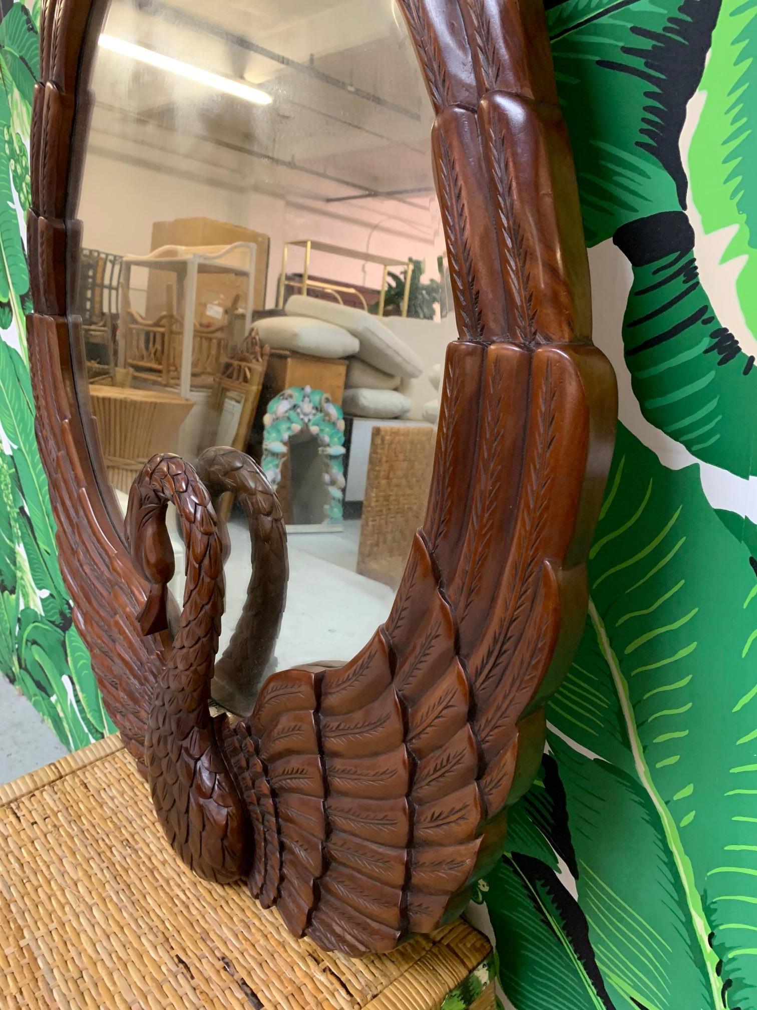 Hand carved wall mirror features sculptural swan carving and a deep, rich finish. Very good condition with only very minor imperfections consistent with age.  M7897