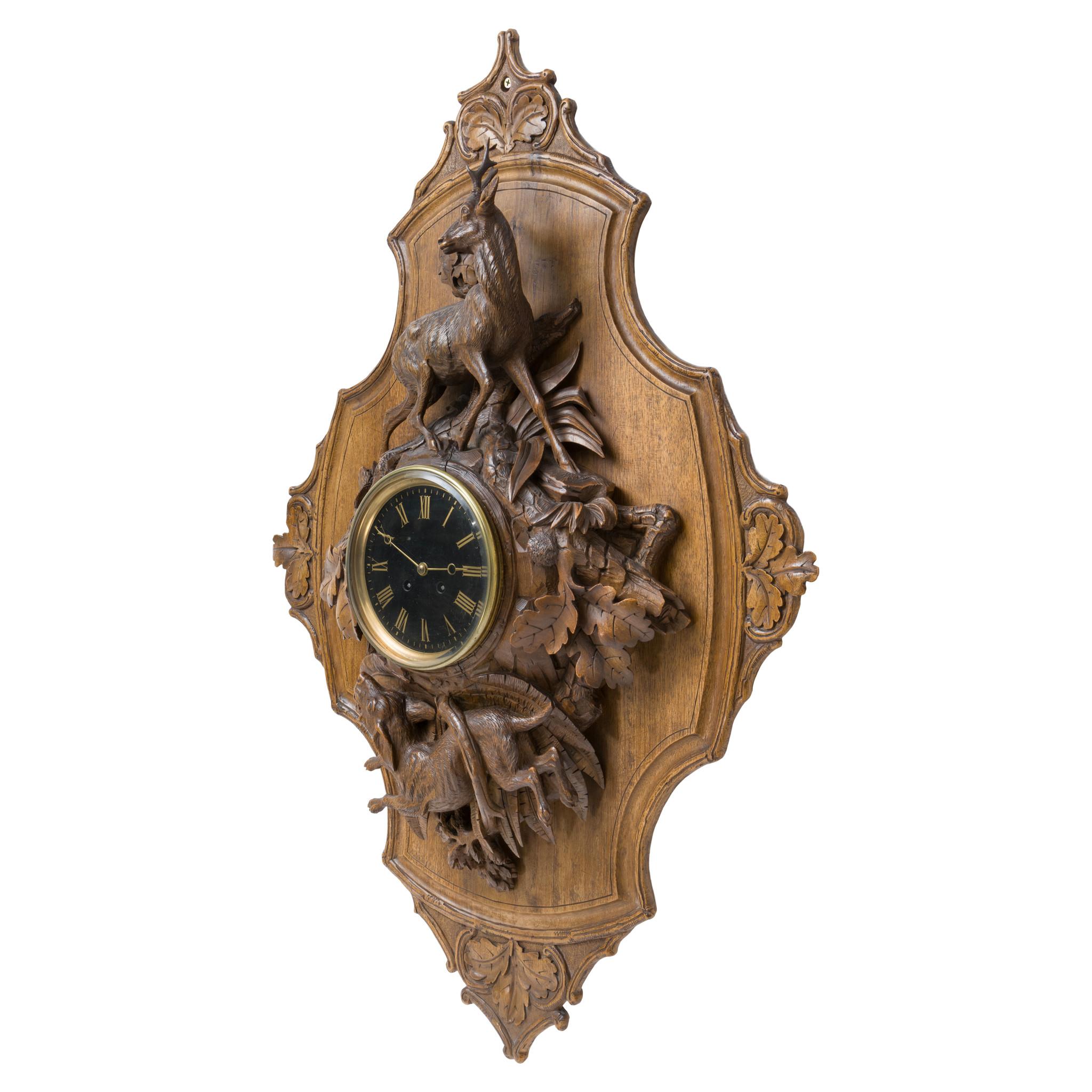 Black Forest carved clock plaque by Johann Huggler (1834-1912) of Brienz - a small town in Bernese Oberland, Canton Bern Switzerland. Signed with a sticker on the bottom that reads 