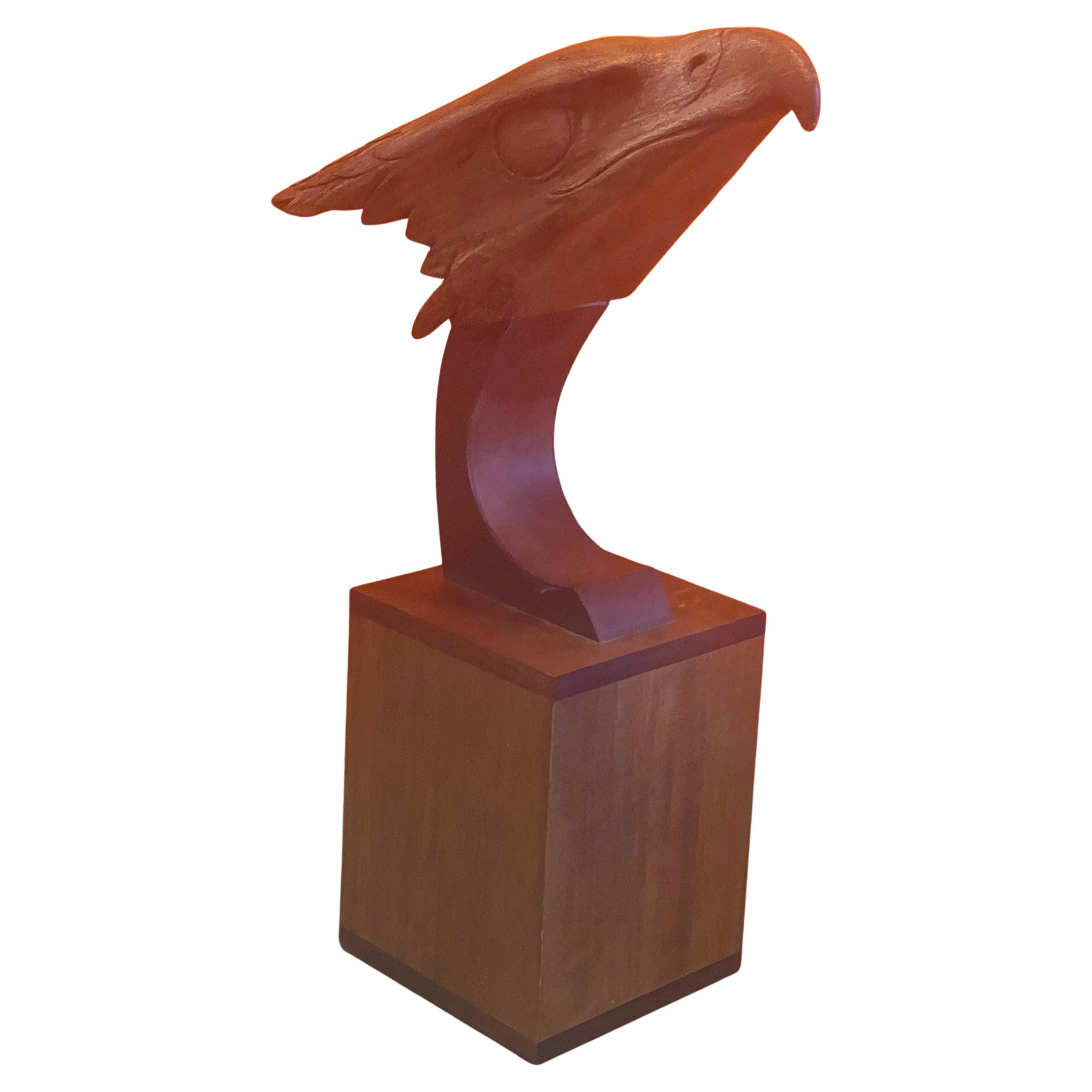 A truly striking hand carved teak bald eagle head sculpture on wood base, circa 1970s. The piece is in very good vintage condition and measures 15