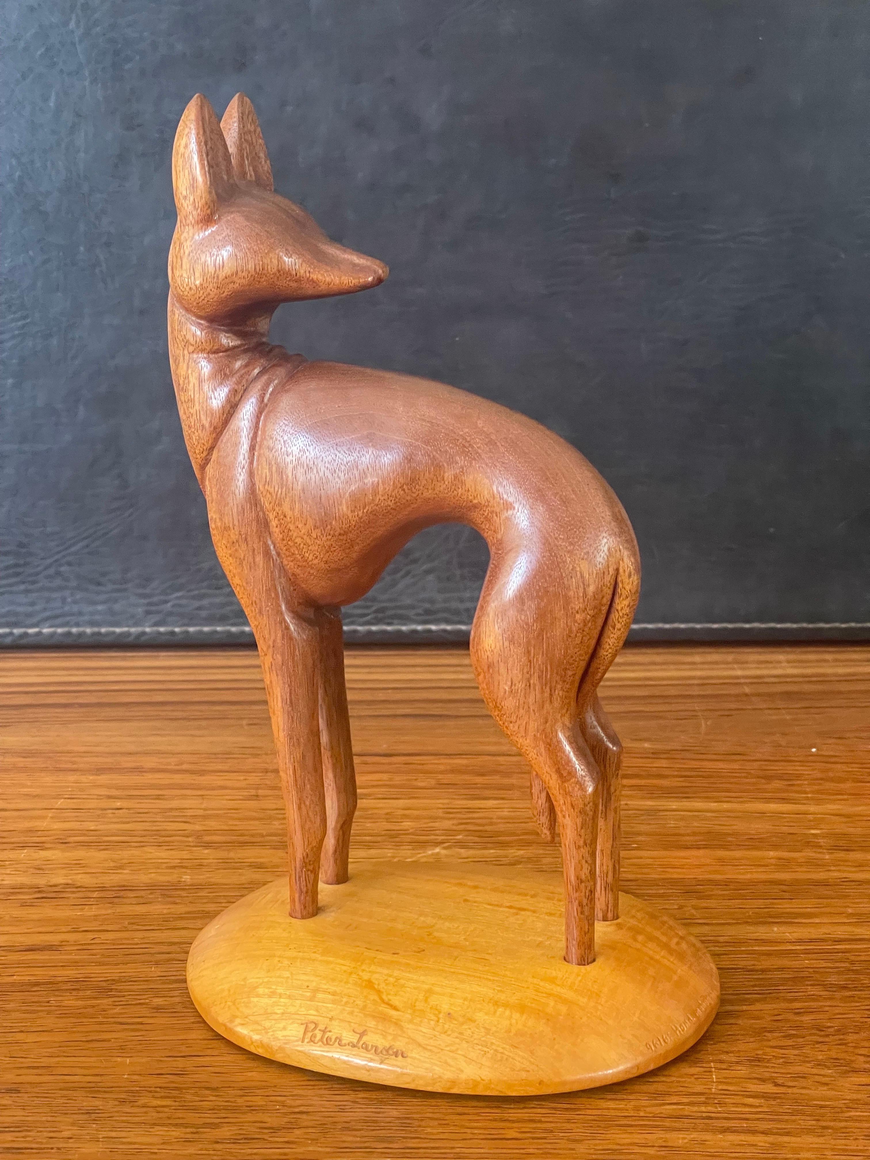 A very cool hand carved teak greyhound sculpture on maple base by Peter Larsen, circa 1980s. The piece is in very good condition with no chips or cracks, is signed on the base and measures 5.5 W x 5.5