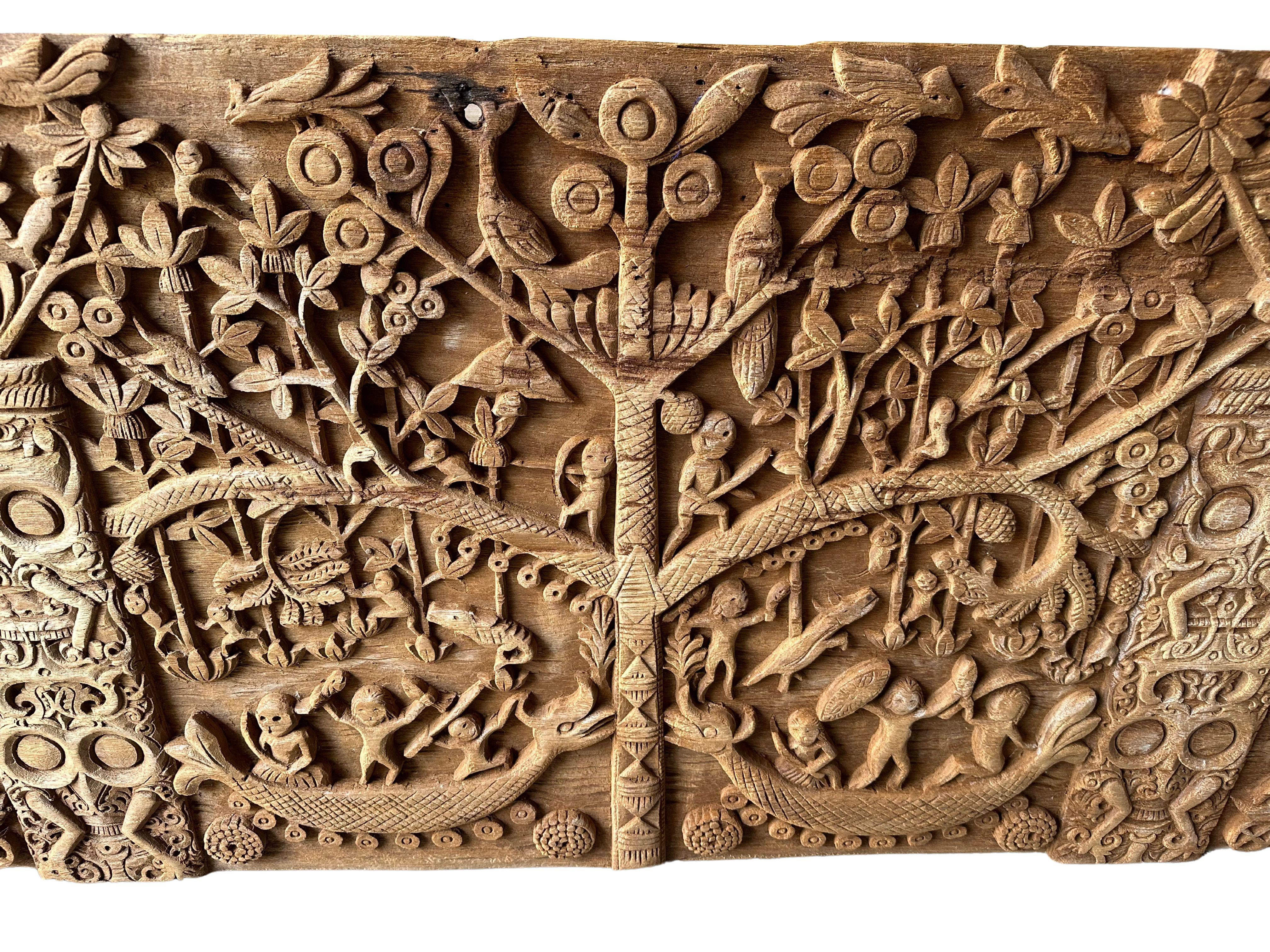 This unique teak carved panel depicts Dayak Tribal mythology. The Dayak people are some hundreds of various native groups found in the interior rainforests of Borneo. This carving depicts the tree of life, which the Dayak people believe exists on
