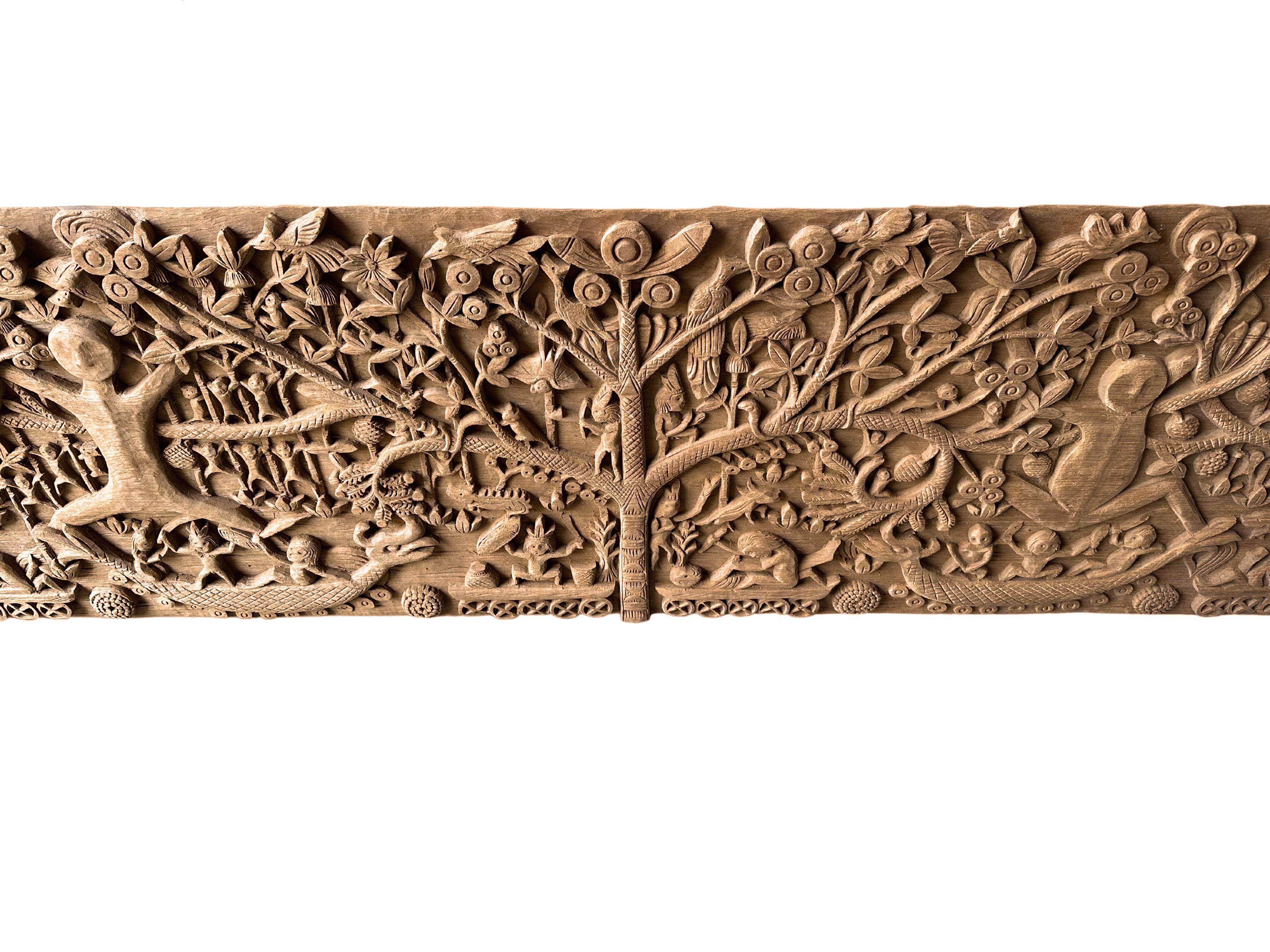 This unique teak carved panel depicts Dayak Tribal mythology. The Dayak people are some hundreds of various native groups found in the interior rainforests of Borneo. This carving depicts the tree of life, which the Dayak people believe exists on