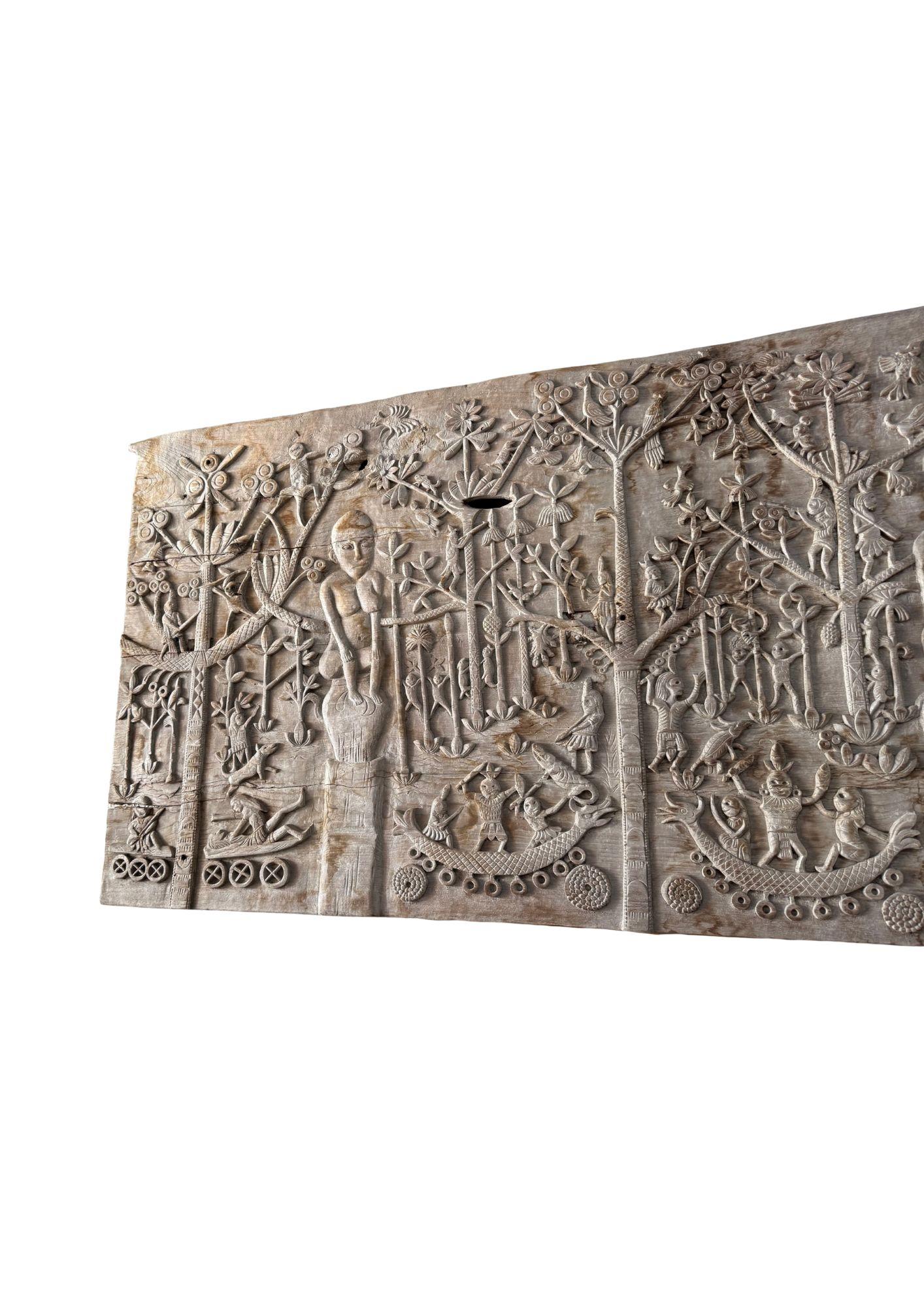 This unique teak carved panel depicts Dayak Tribal mythology. The Dayak people are some hundreds of various native groups found in the interior rainforests of Borneo. This carving depicts the tree of life, which the Dayak people believe exists on
