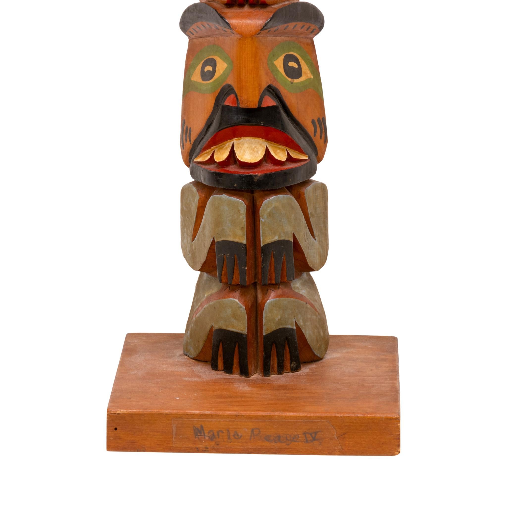 Tlingit hand-carved totem with wings painted in a Norwegian style. Marked on back Maria Pease IV, Tlingit with Norgwegian influence. Three-figure totem, finely carved and painted, featuring bright colors of red, green, and blue. Would display nicely