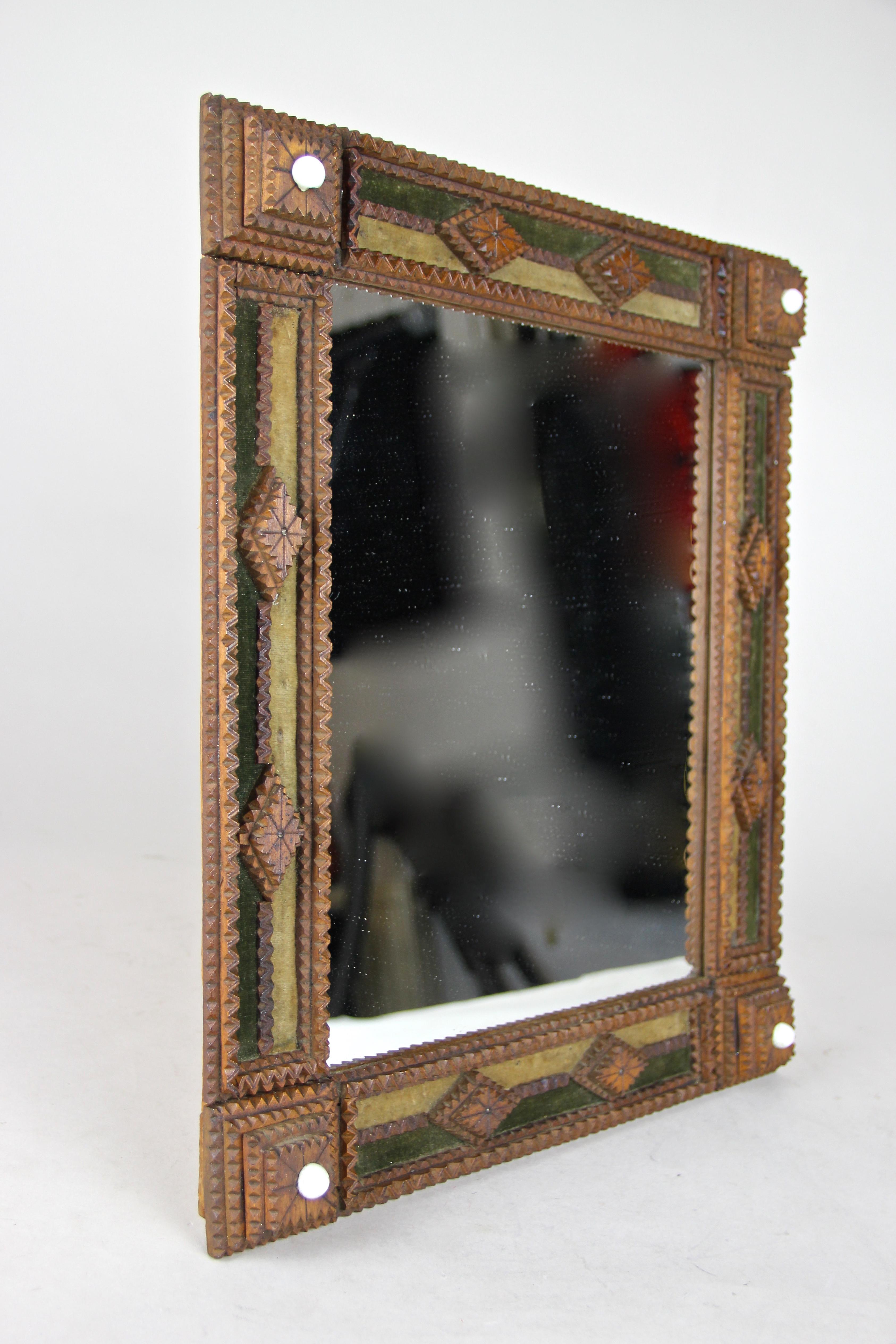 Unusual hand carved Tramp Art mirror coming from the later 19th century, circa 1870 in Austria. Made of basswood, this ornate worked 
