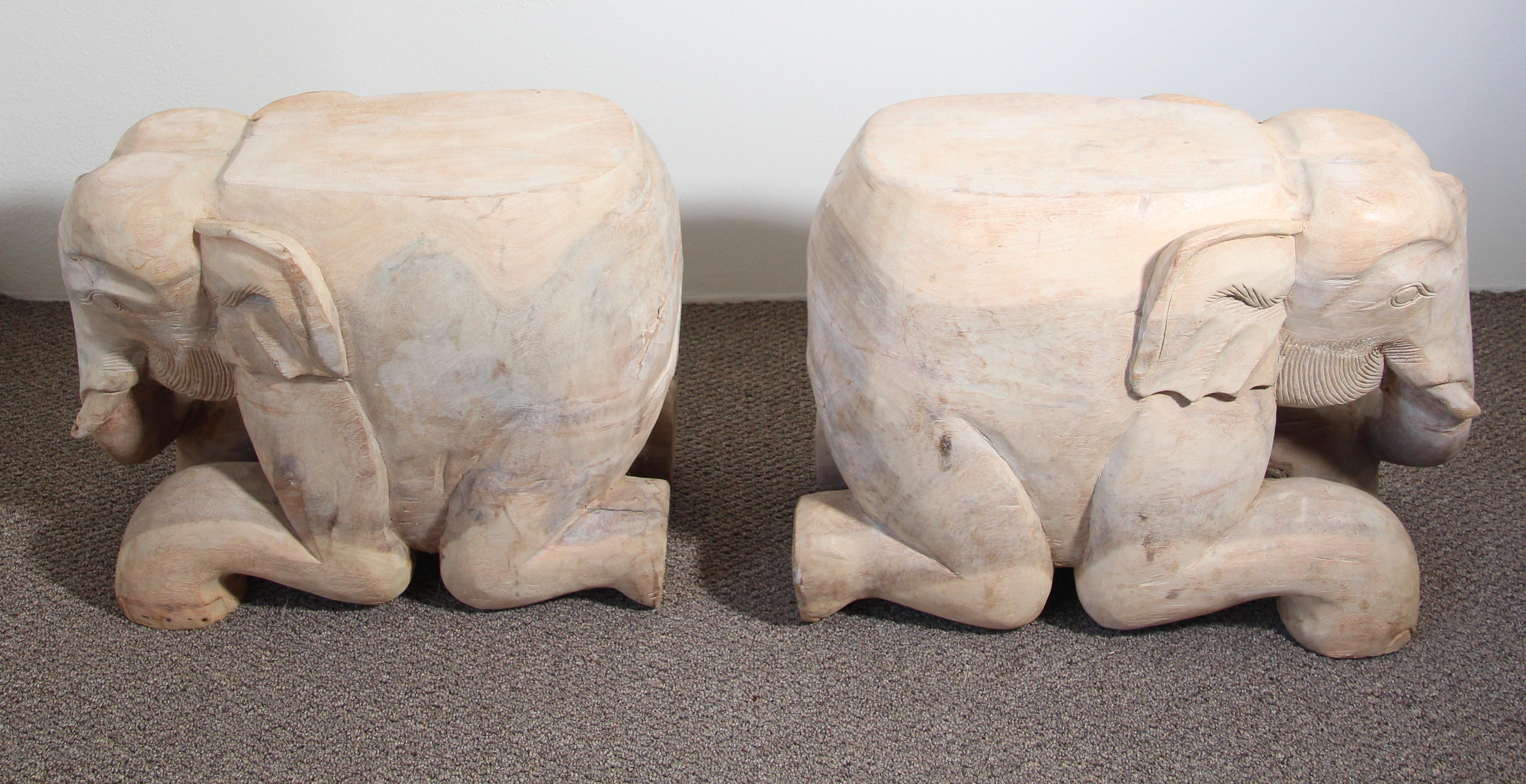 Hand-carved vintage wooden South Asian elephant stools, or side tables, very nice abstract hand-carved on one piece of wood.
A wonderful vintage pair of solid wood hand carved elephant garden seats. 
Southeast Asian style indigenous hardwood with