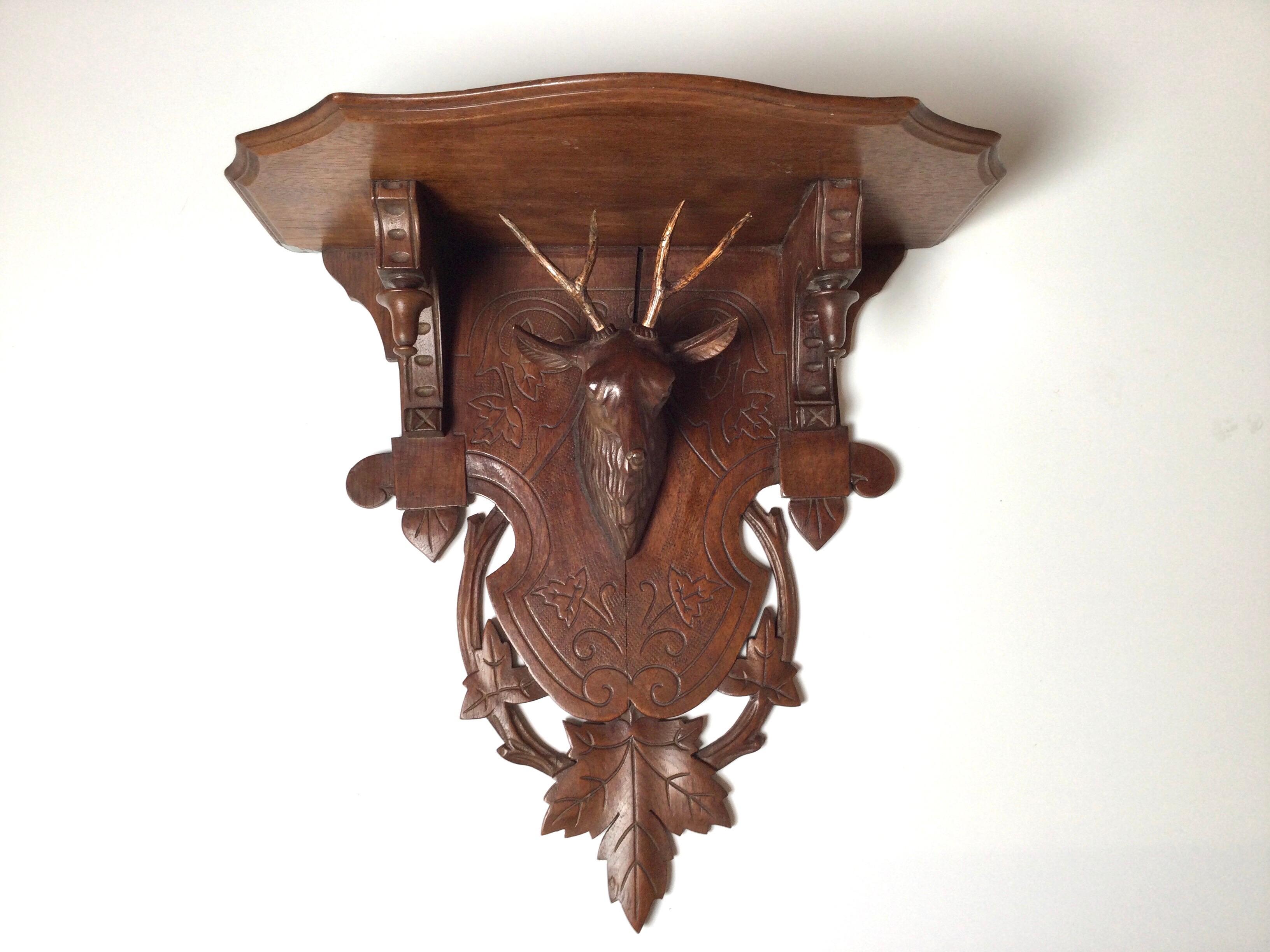 A beautifully carved Black Forrest hand carved walnut wall shelf with deer head. Austrian or German, circa 1900. Excellent condition 15 wide, 14 high, 7.5 deep.