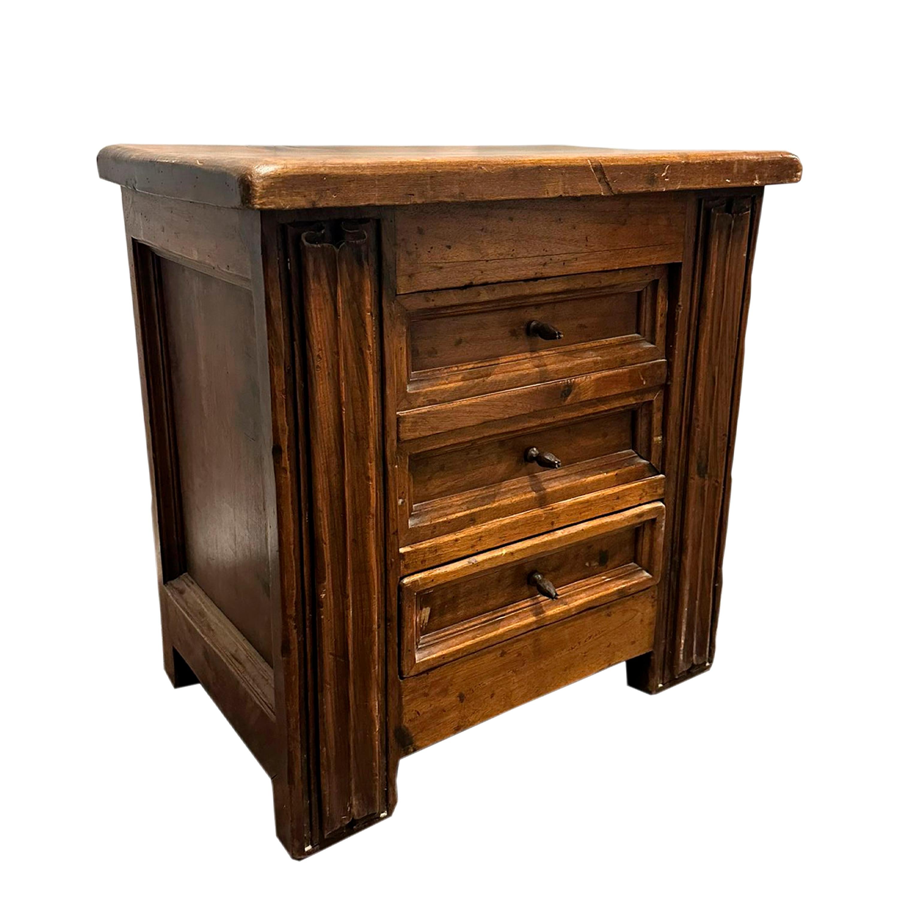 Spanish 17th century three-drawer chest in solid carved walnut wood, with molded sides following late Gothic designs, and wrought iron handles. 