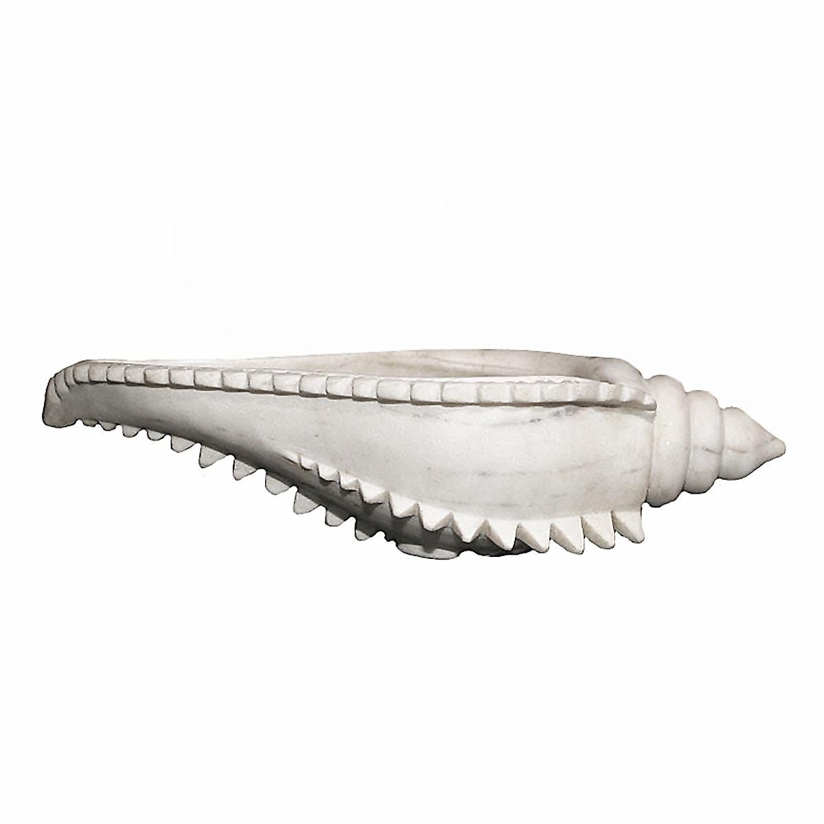 A hand carved white marble bowl from India, in the shape of a large sea conch.