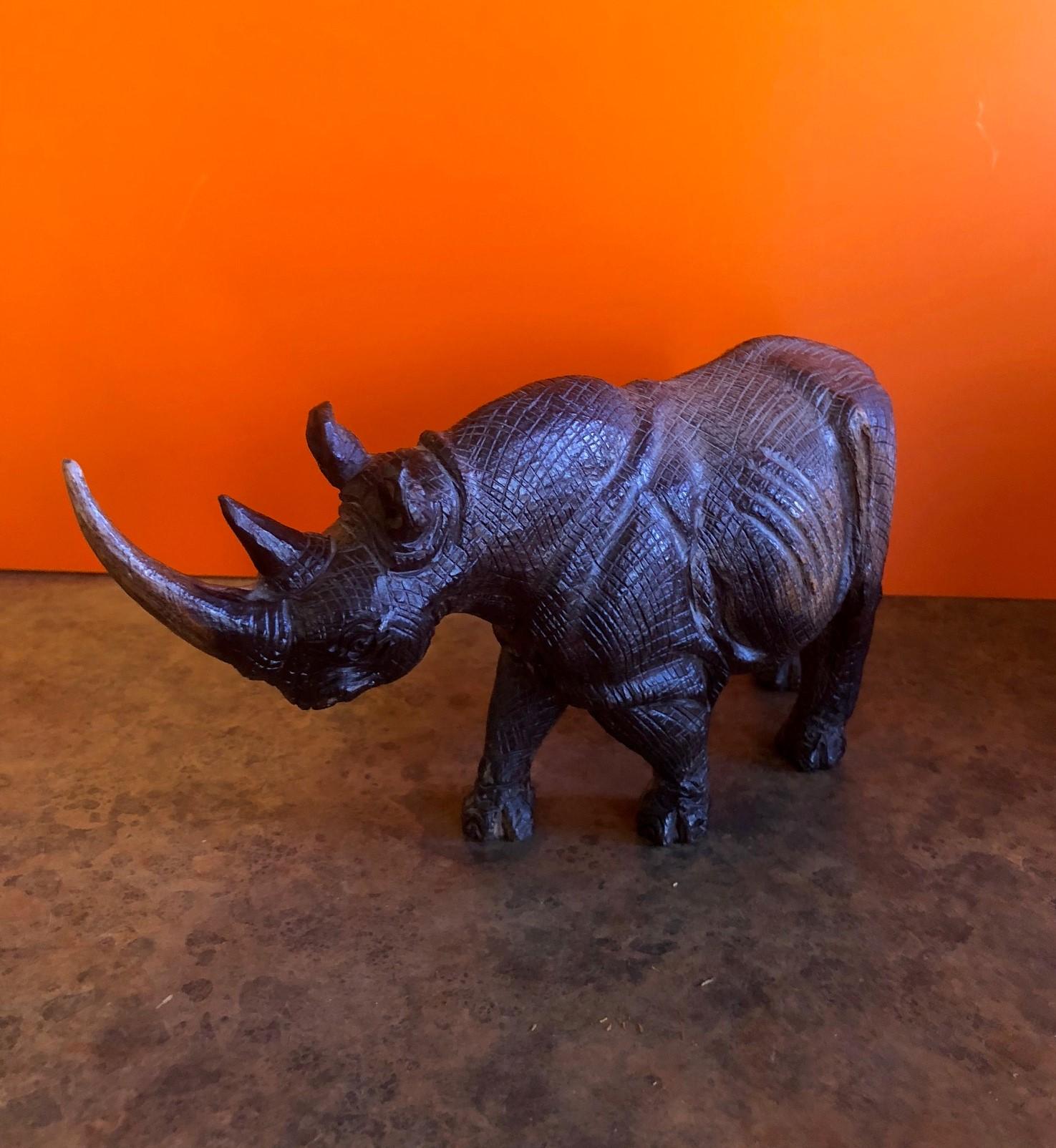 Incredibly detailed hand-carved white rhino sculpture signed by Khoza Frans, circa 1980s. The intricacy of the piece is amazing as the hide looks almost like leather; it appears to be hand carved from an African hardwood.