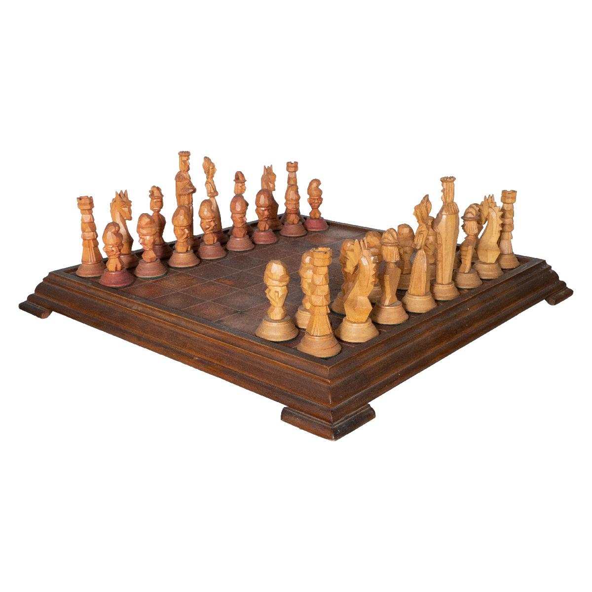 Intricately hand-carved wooden chess with leather game board. King piece measures 4.25