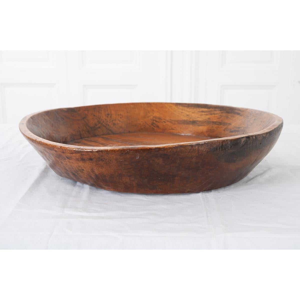This is an English 19th century hand carved wood bowl - well used and beautiful. It has a metal patch on the side to strenghten it. The sides are very thick and the inside bottom has a faded design on it. The bowl would look great on any table or