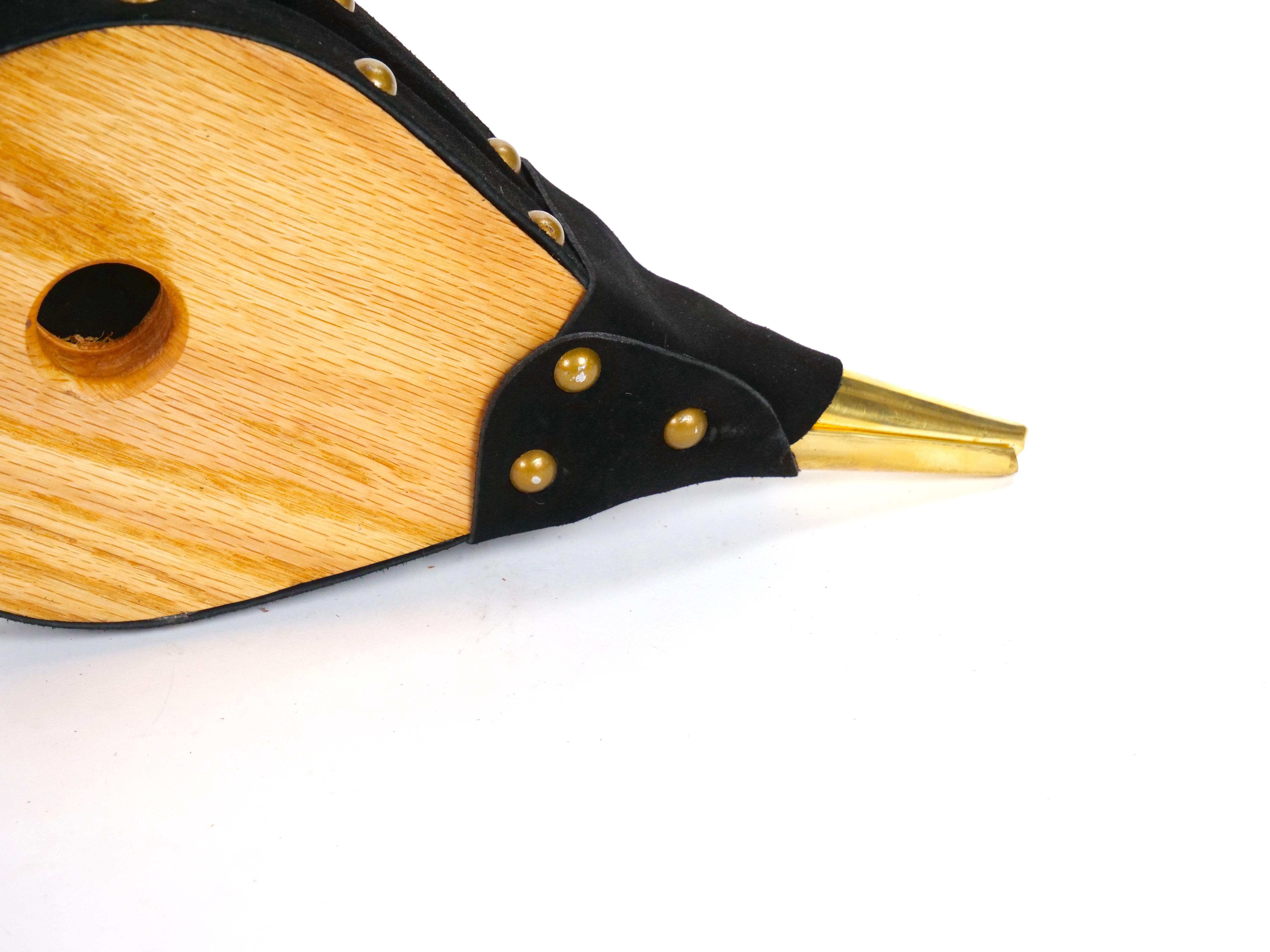Enhance your fireplace with this elegant and functional handmade bellows, crafted in North America in the late 20th century. This exquisite piece combines quality wood, brass, and leather, offering both beauty and utility. The bellows features a