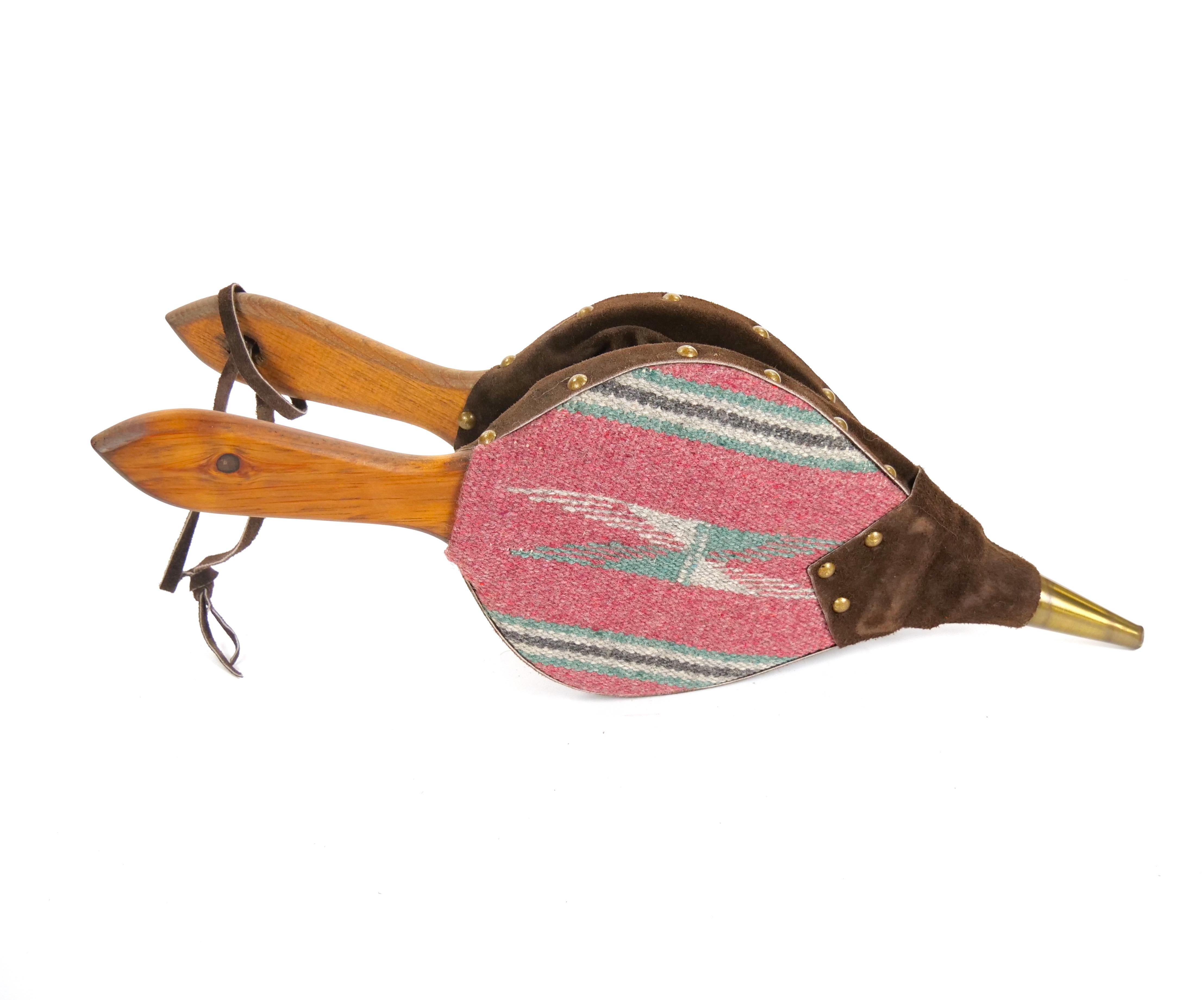 Enhance your fireplace with this elegant and functional handmade bellows, crafted in North America in the mid 20th century. This exquisite piece combines quality wood, Upholstery, brass, and leather, offering both beauty and utility. The bellows