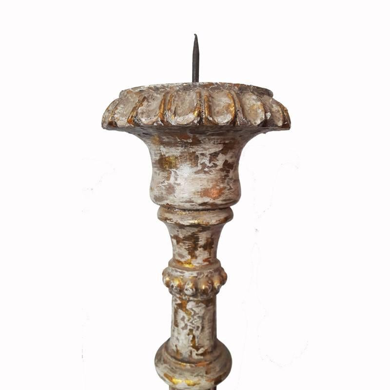 Tall, hand-carved wood candlestick from India. Gilt finish, distressed. Holds candles up to 4 inches in diameter. 