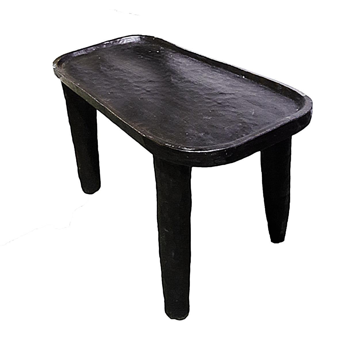 A vintage rustic table, hand carved in Ethiopia, circa 1980. Dark finish. Ideal as a coffee table or an end table in any contemporary / organic decor.